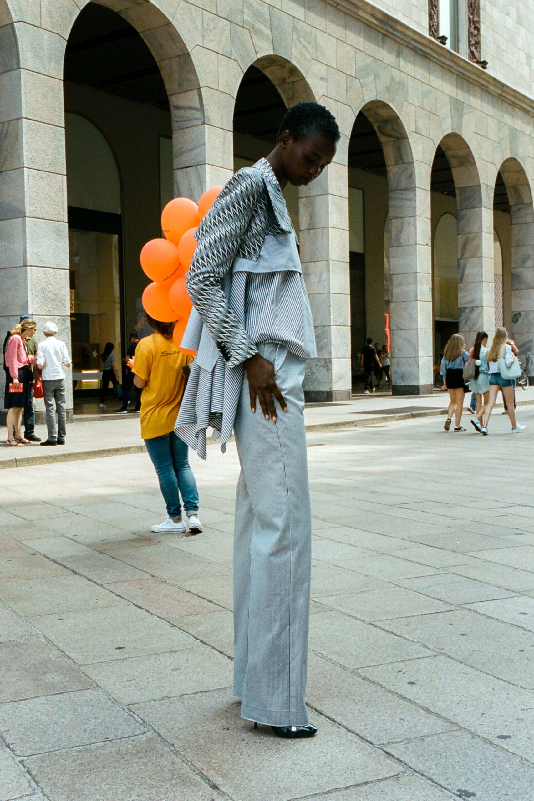 tailored black and white striped blazer with fitted gray pants
