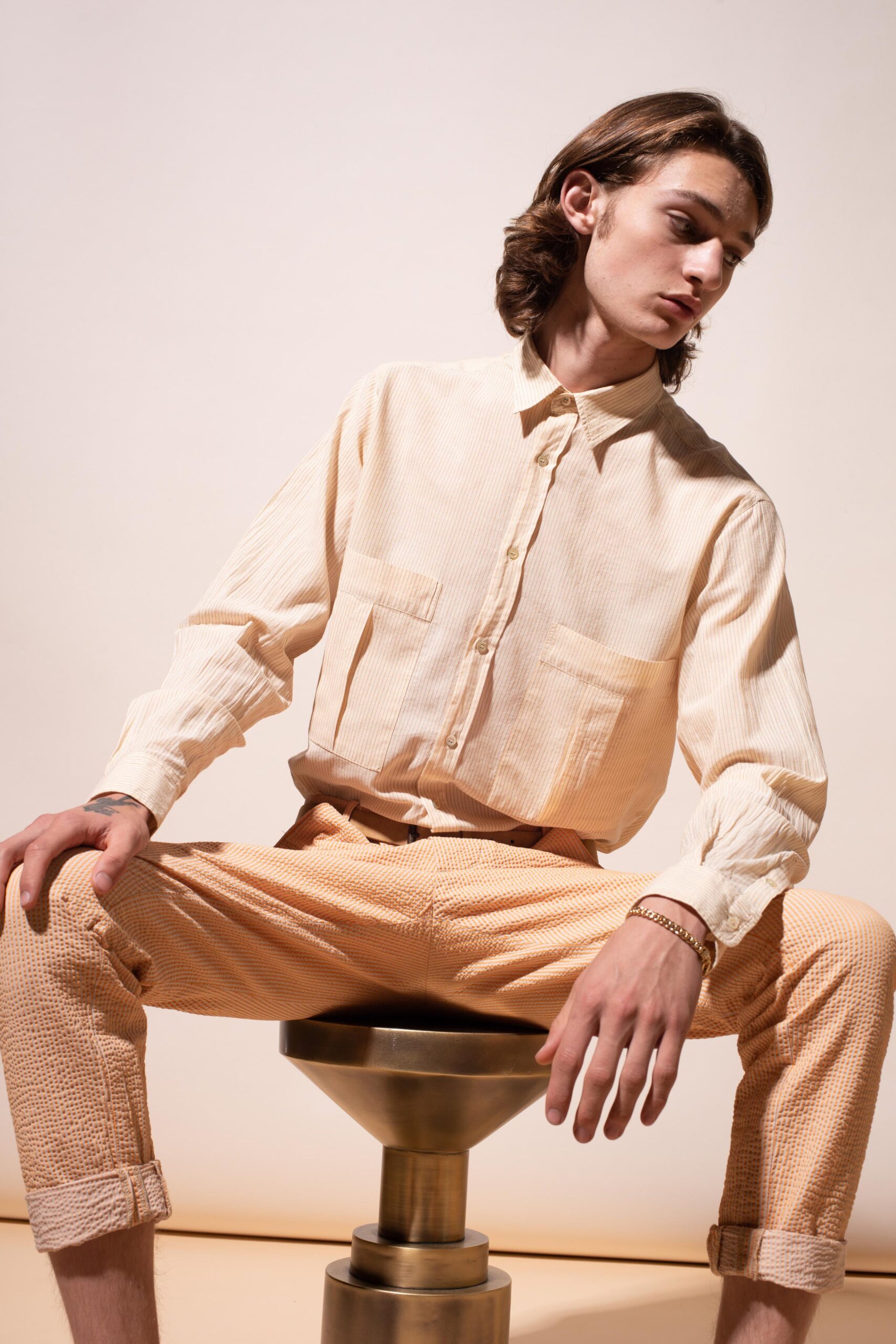 beige striped shirt and orange pants