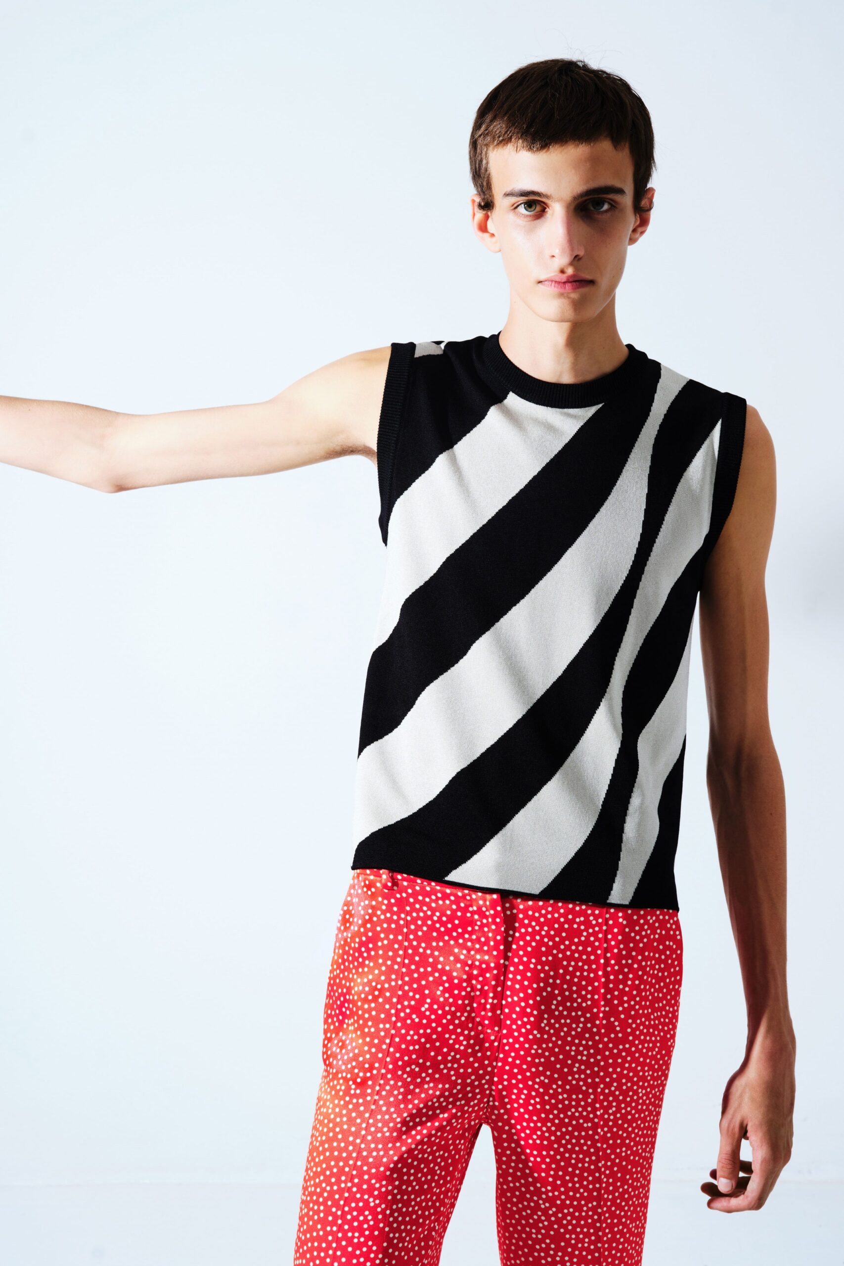 black and white printed top with red polka-dot pants