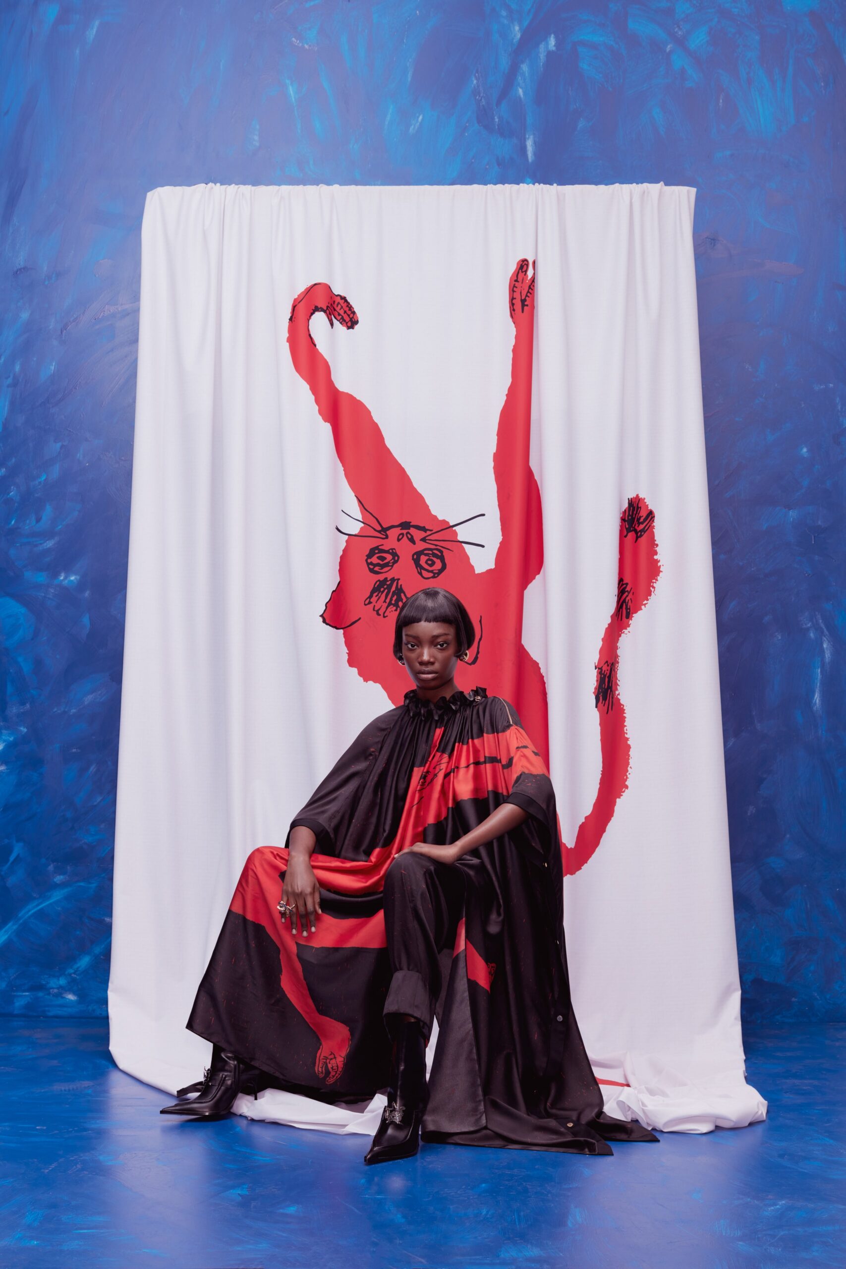 black and red relaxed cape with fitted pants