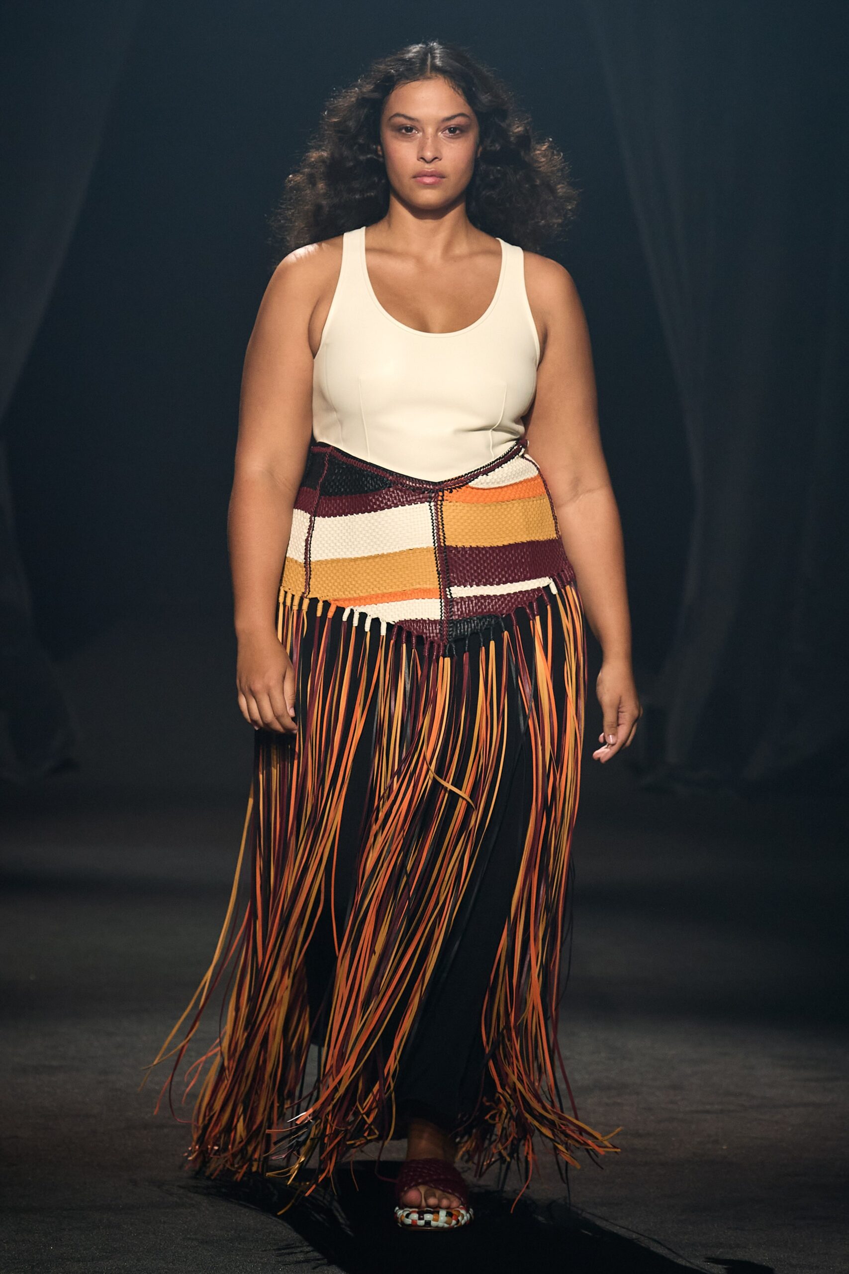 white fitted sleeveless top with fringed skirt