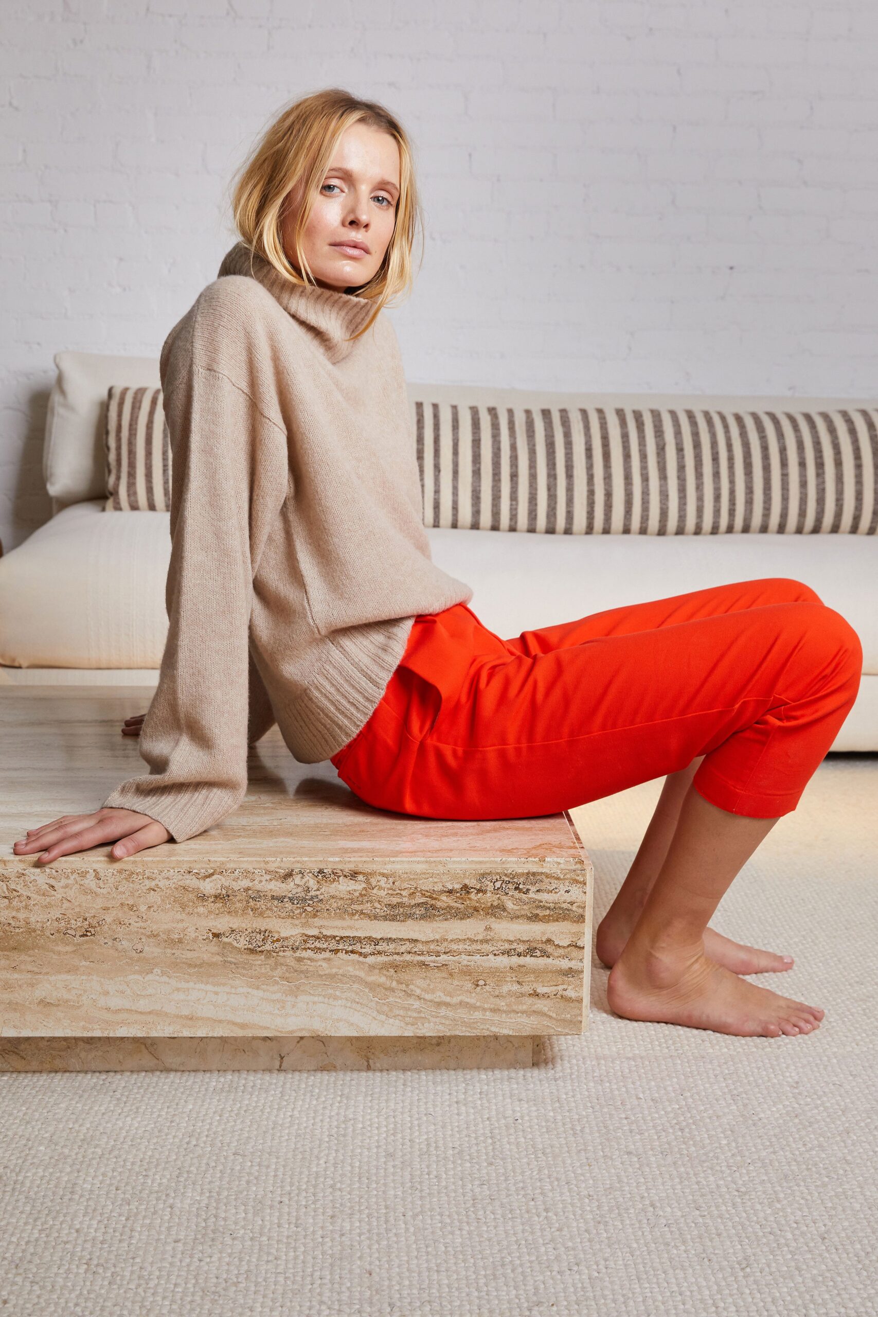 beige wool turtleneck sweater and red pants