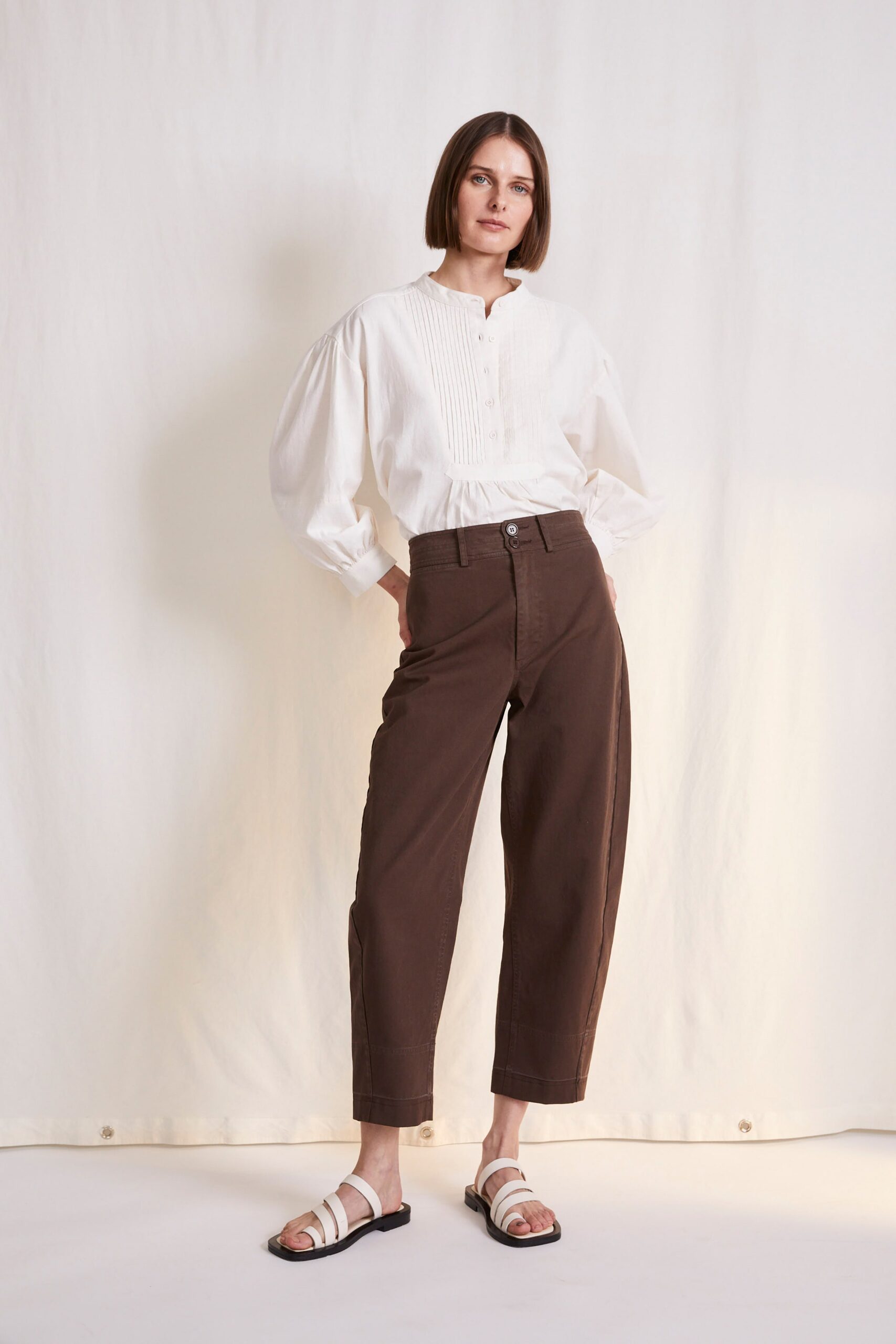 white relaxed blouse and brown pants