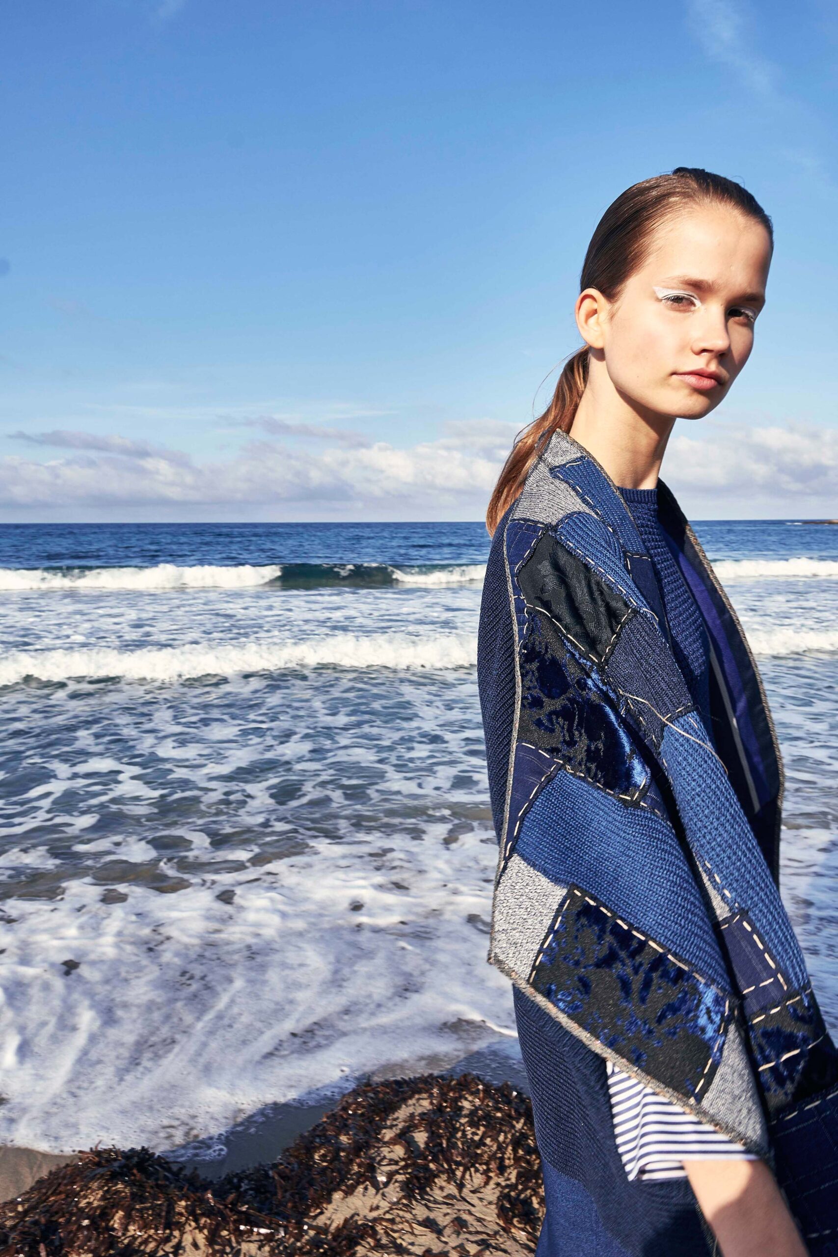 blue patchwork cape and striped top