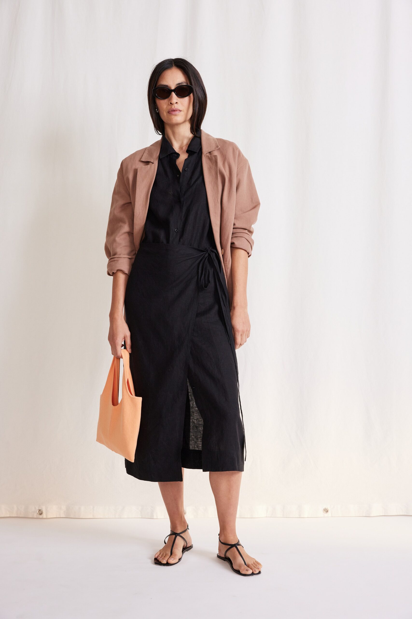 black fitted dress with beige jacket