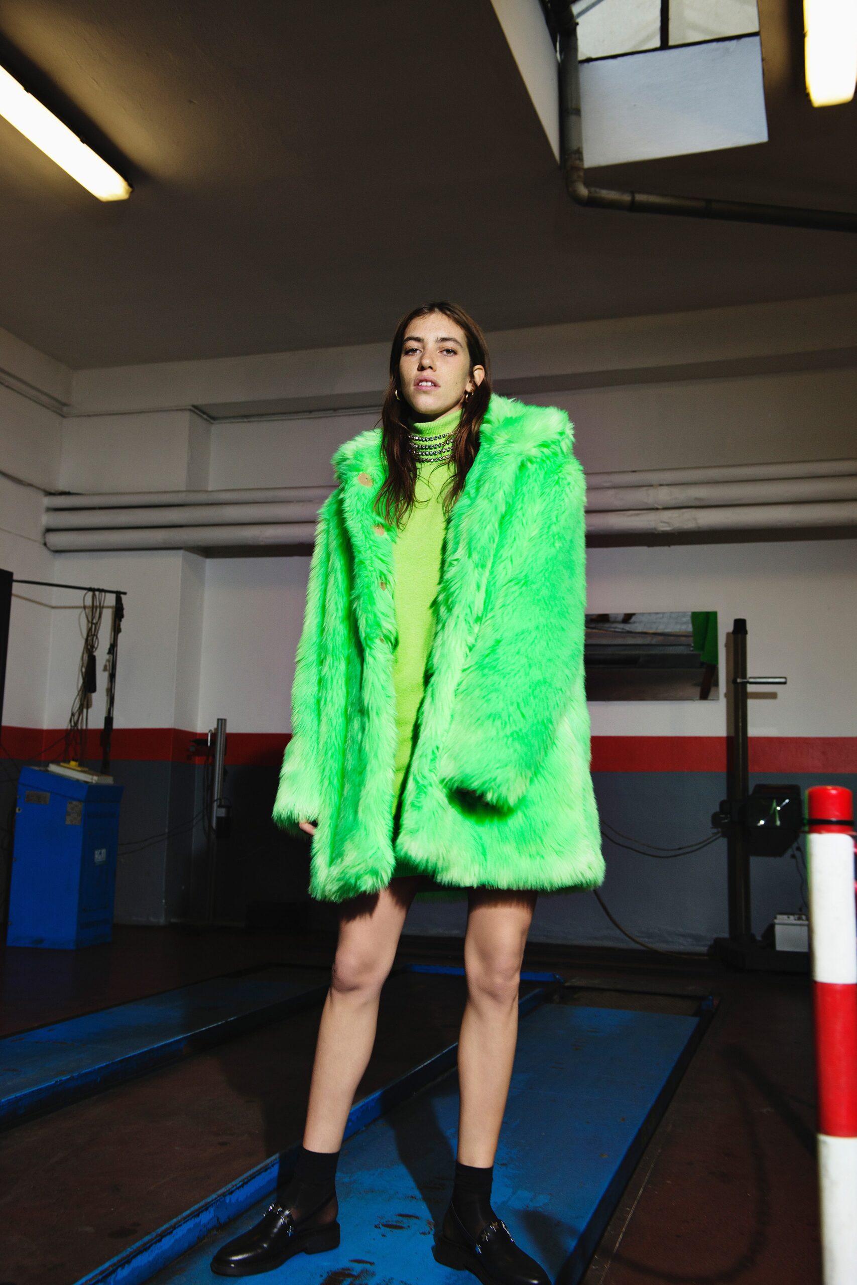 green faux-fur oversized coat and fitted dress
