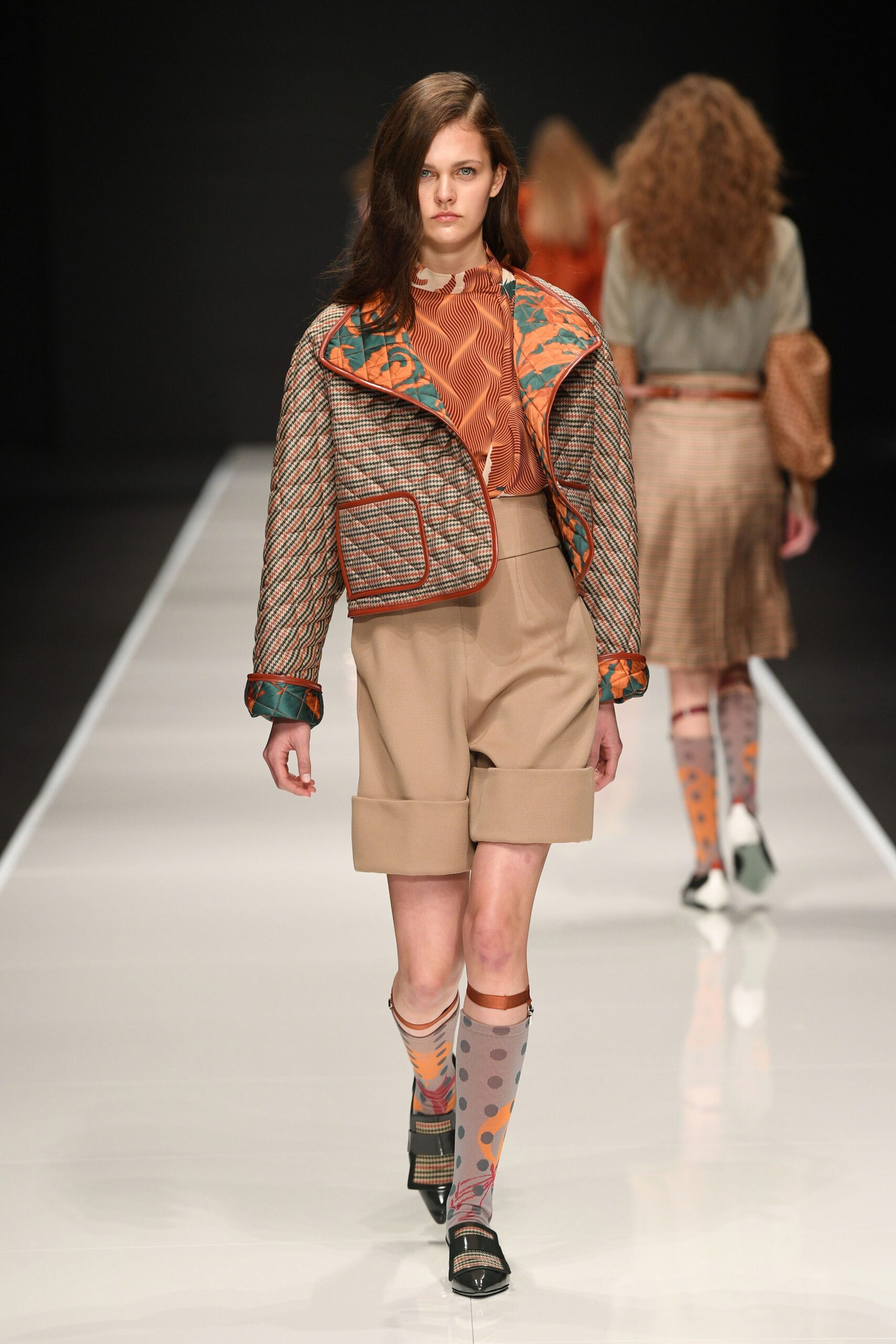 fitted brown jacket with beige shorts