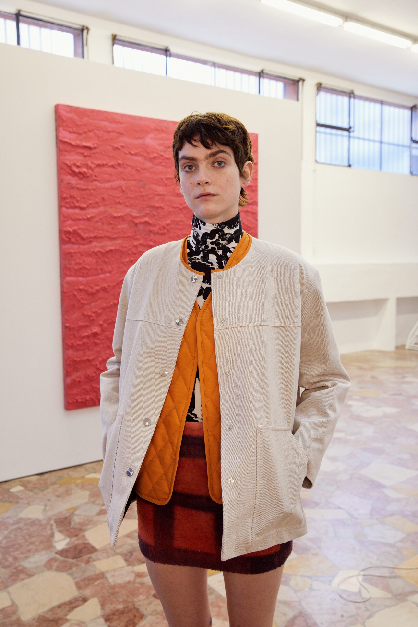 beige jacket black and white top red pencil skirt