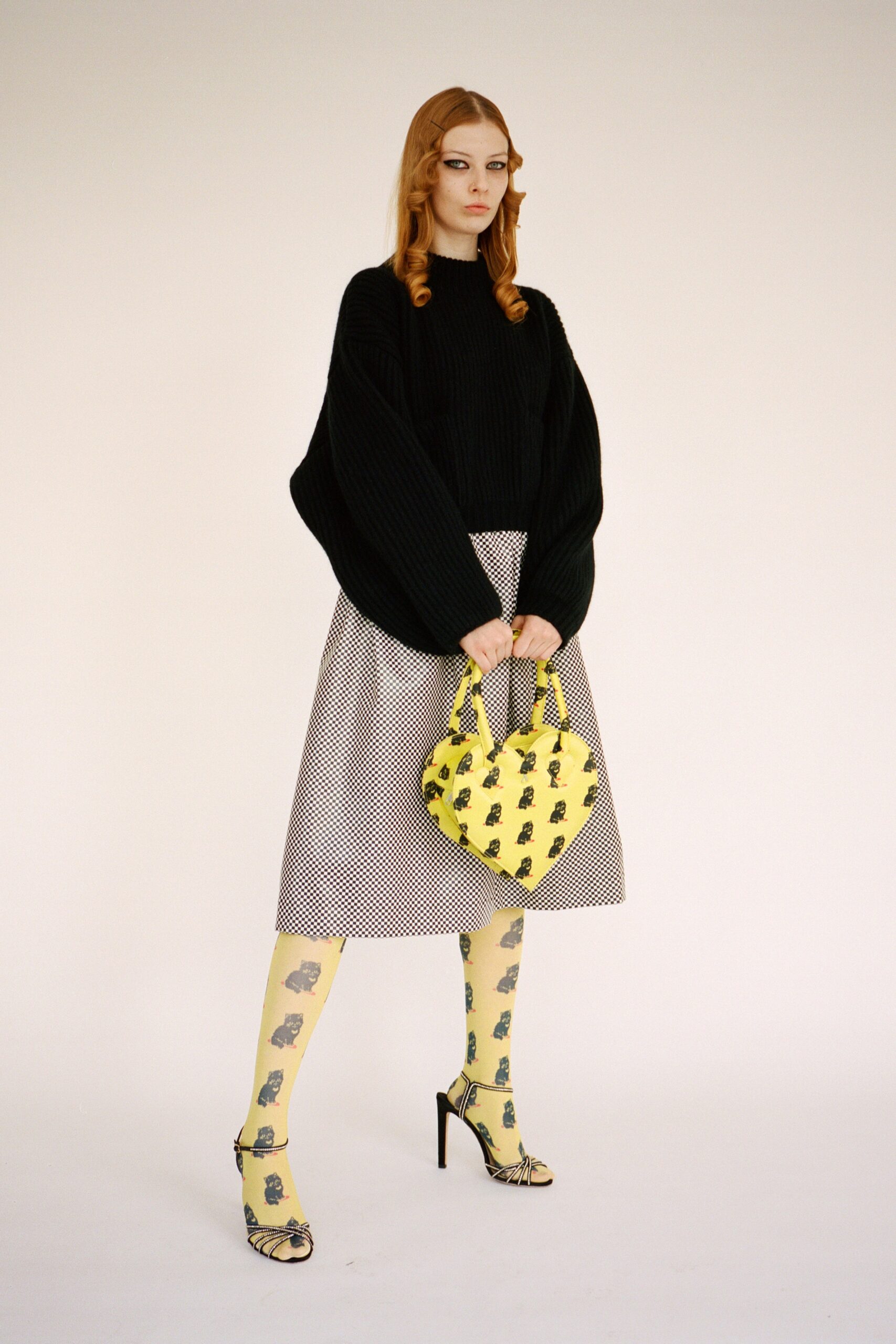 oversized black sweater with pleated skirt