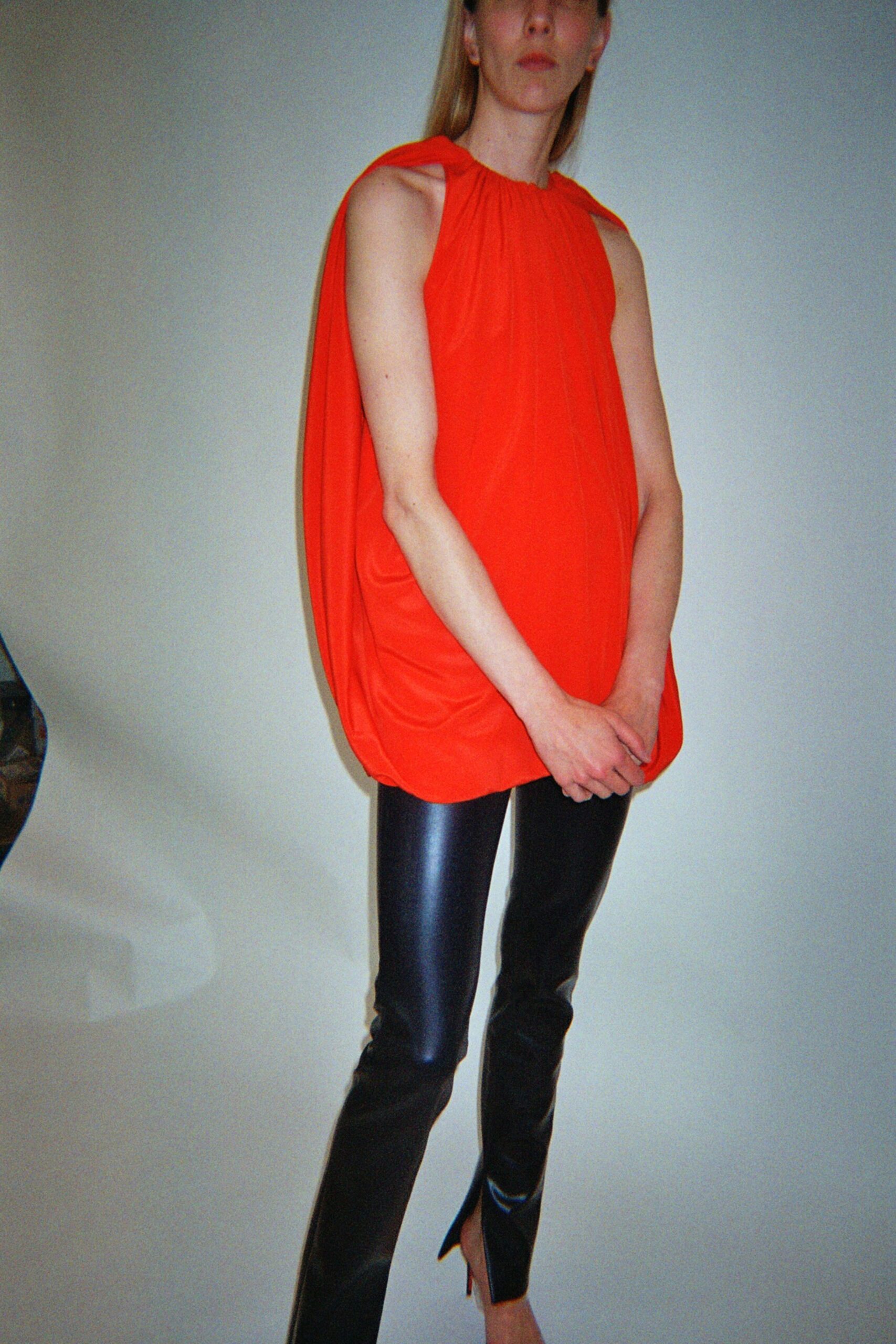 red silk sleeveless high-neck relaxed draped top
