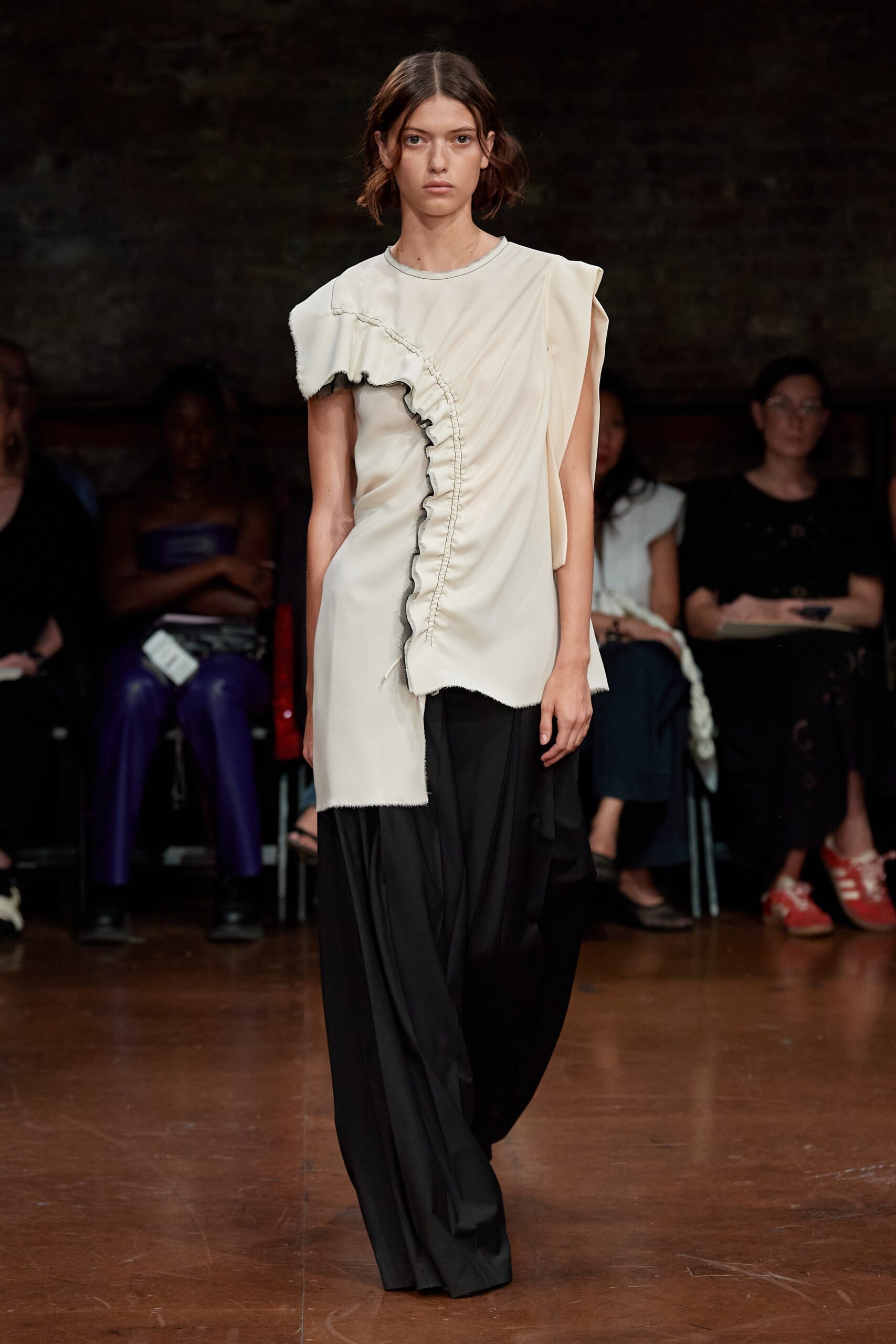 beige asymmetric top with black wide-leg pants