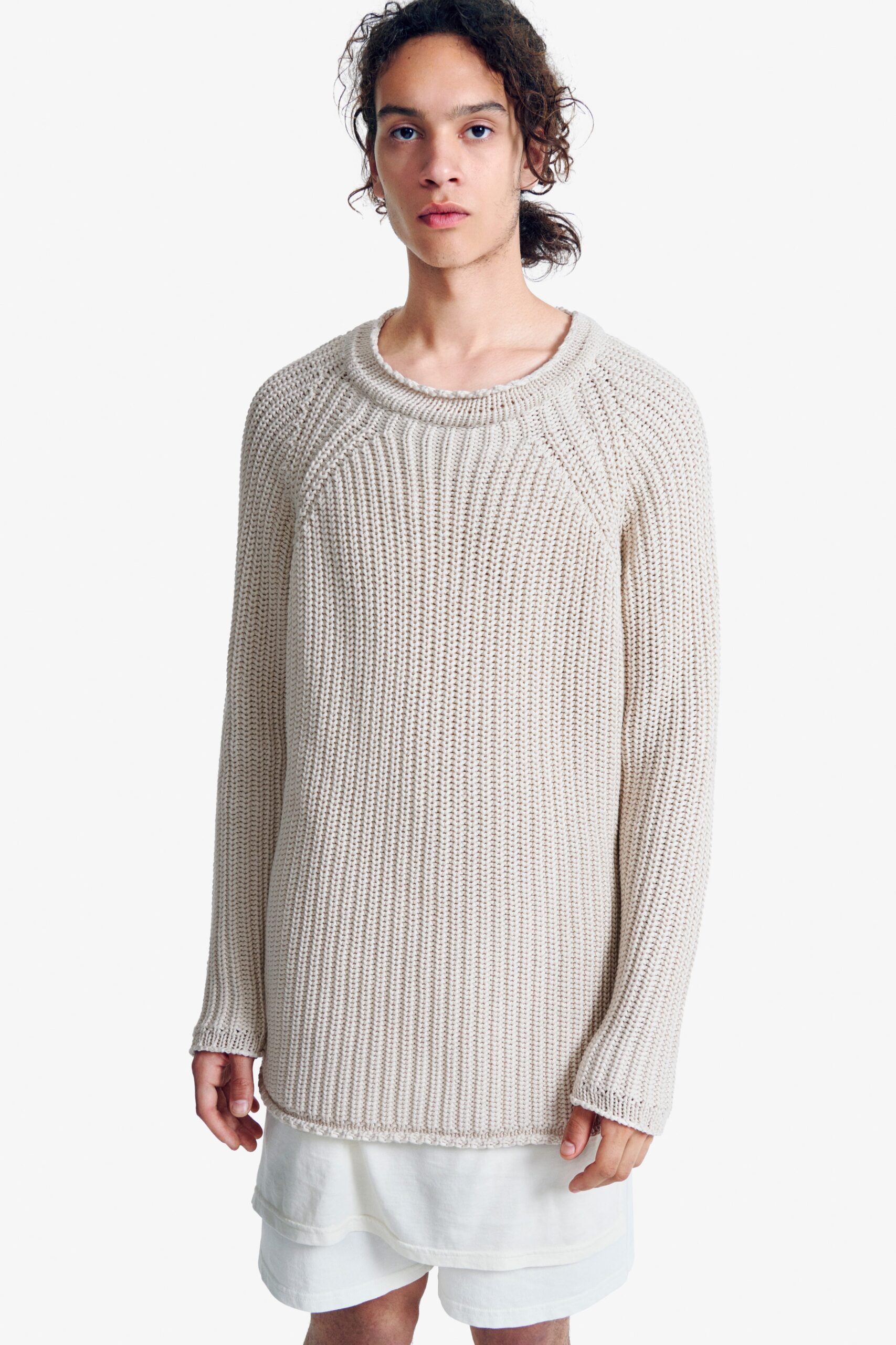 beige relaxed sweater with white mini dress