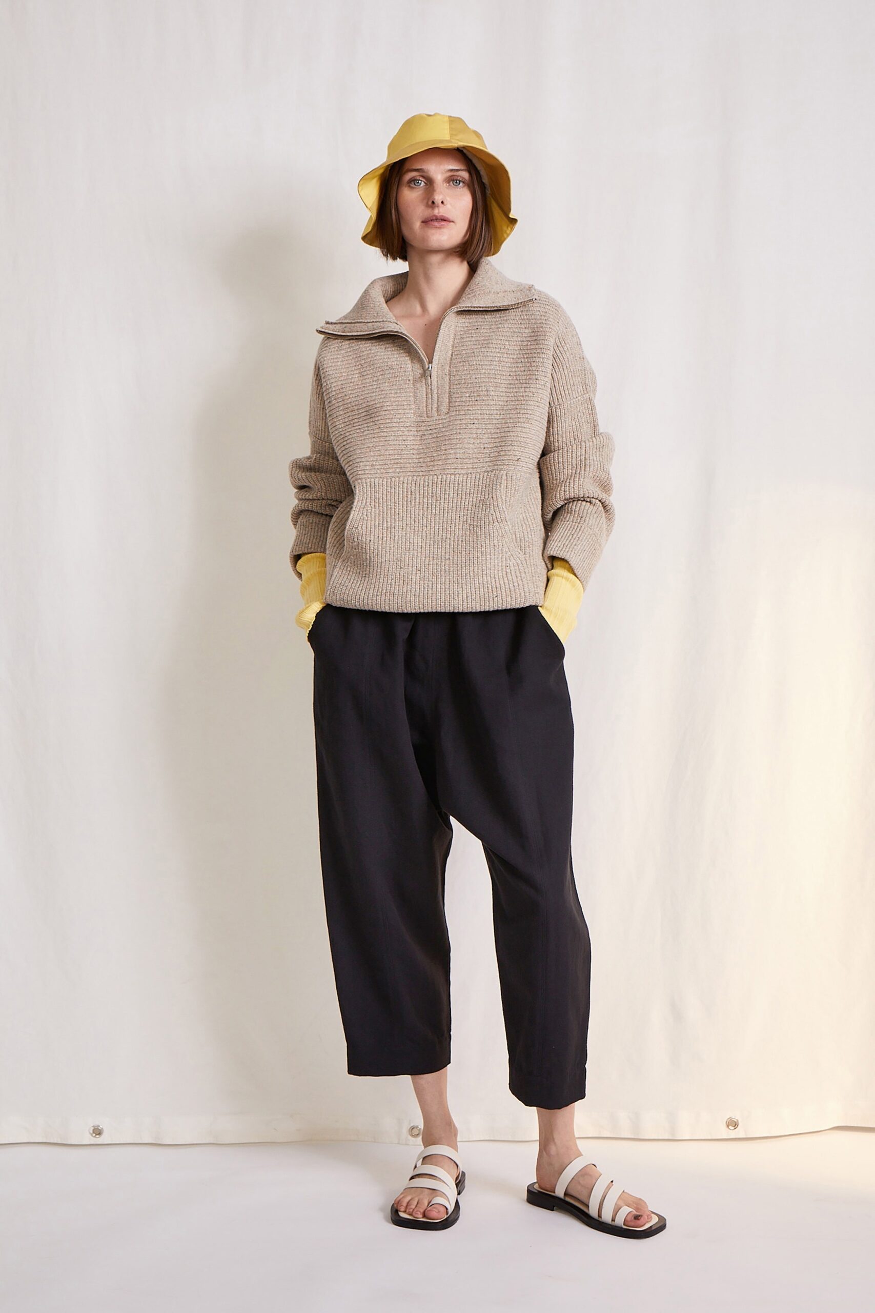 beige relaxed sweater with black pants