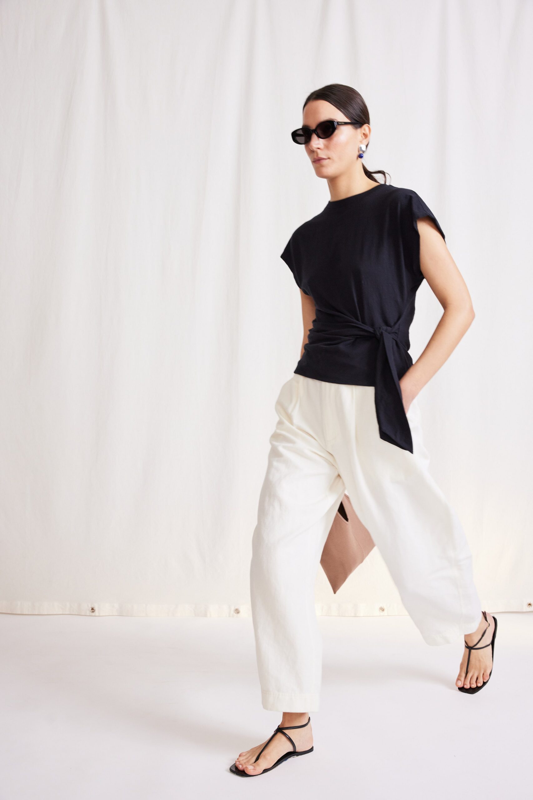 black fitted top with white pants