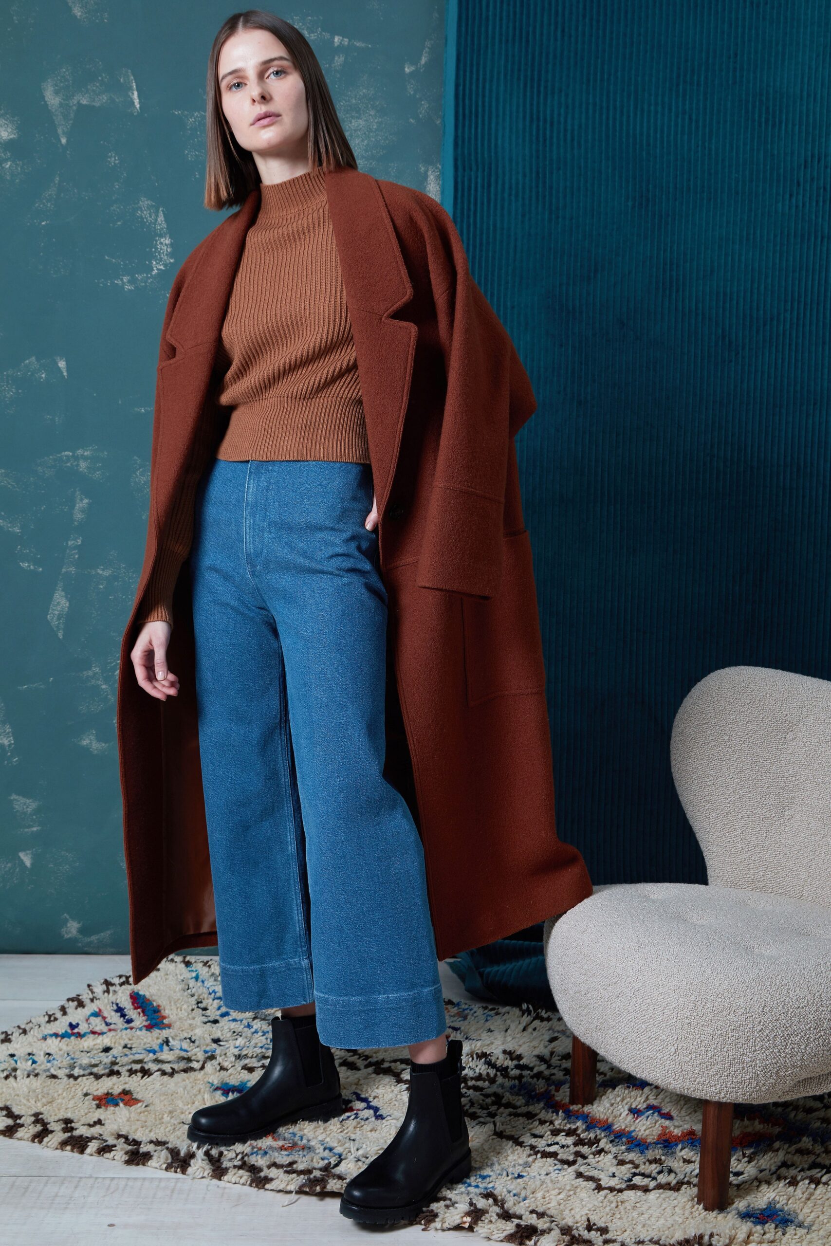brown oversized coat with sweater and jeans