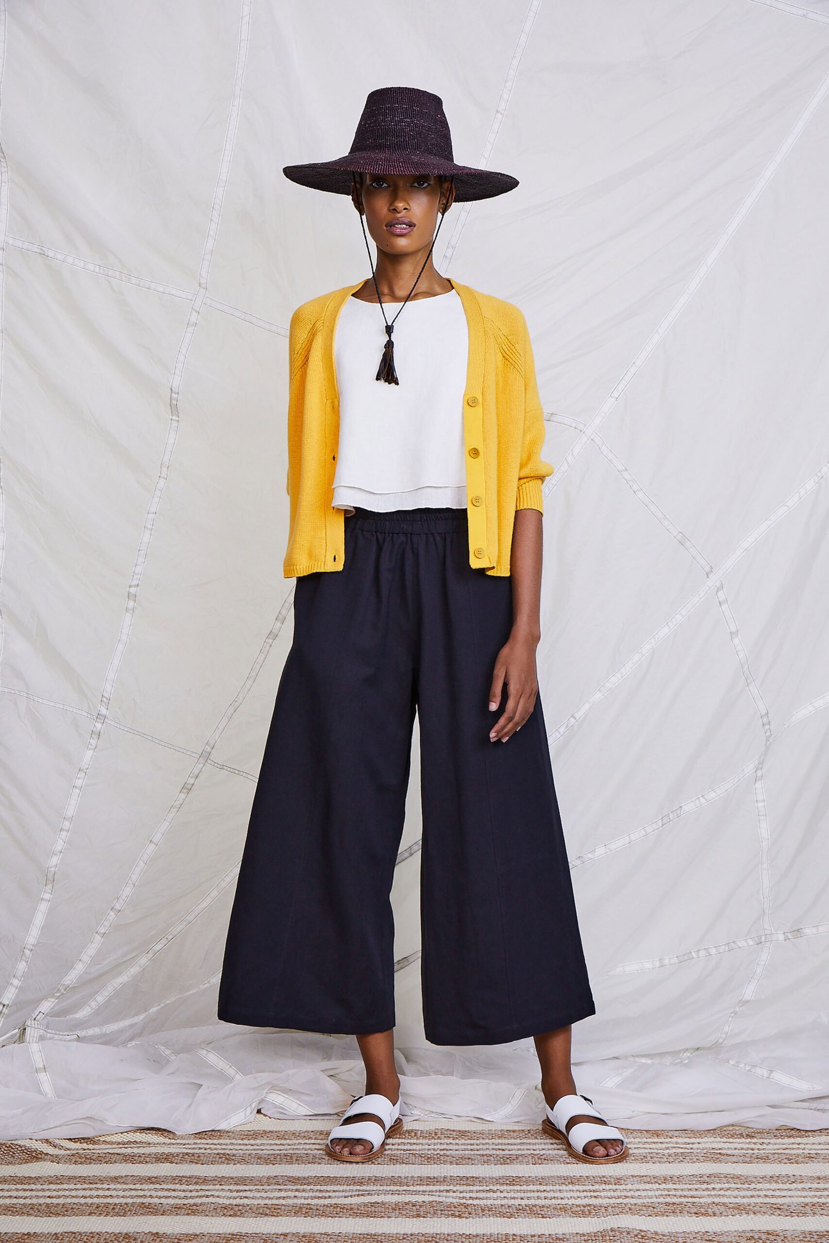 yellow cardigan white top black pants