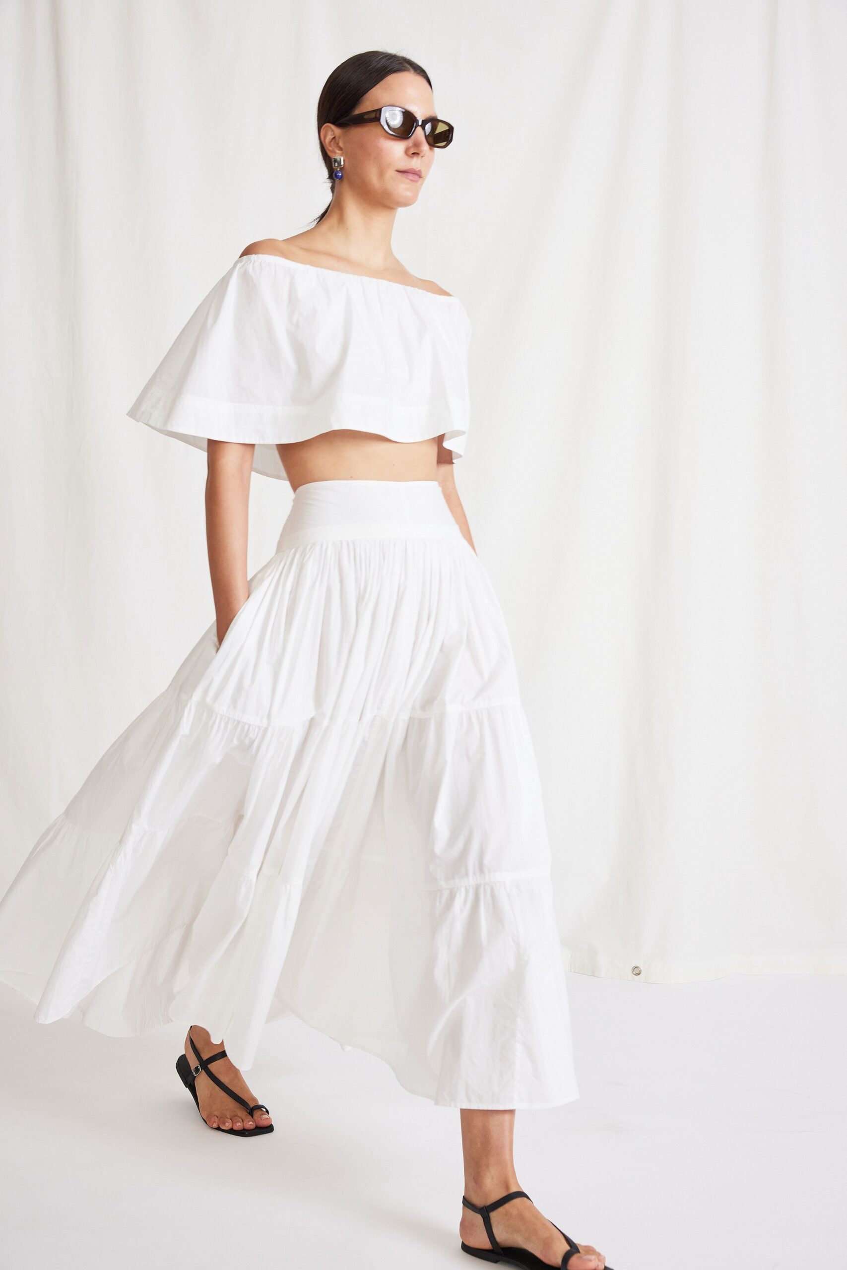 white cotton sleeveless off-shoulder fitted flared flowing top