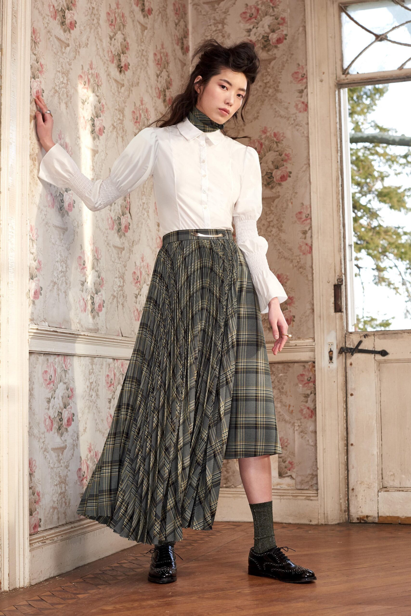 white fitted shirt and green pleated skirt
