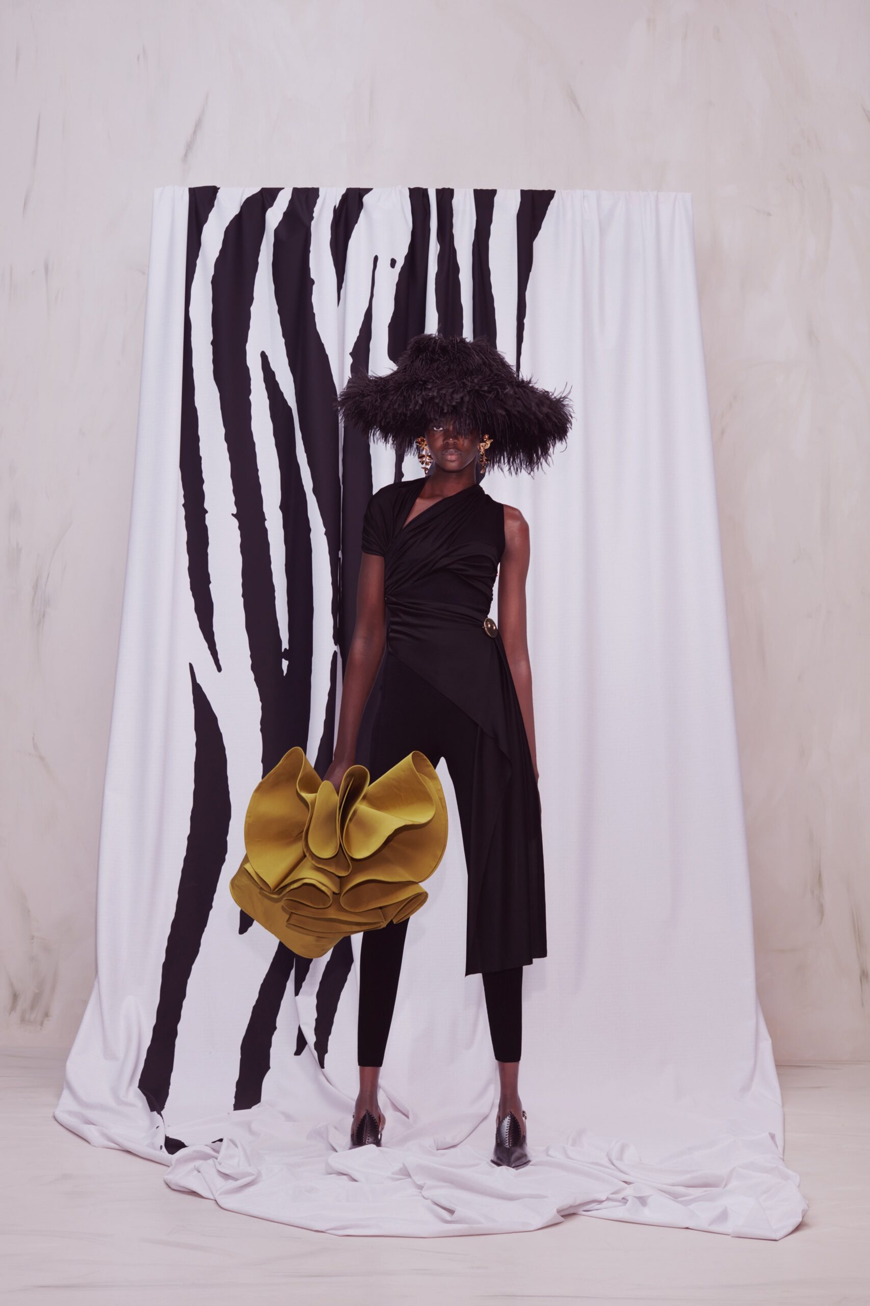 black asymmetric dress with green bag