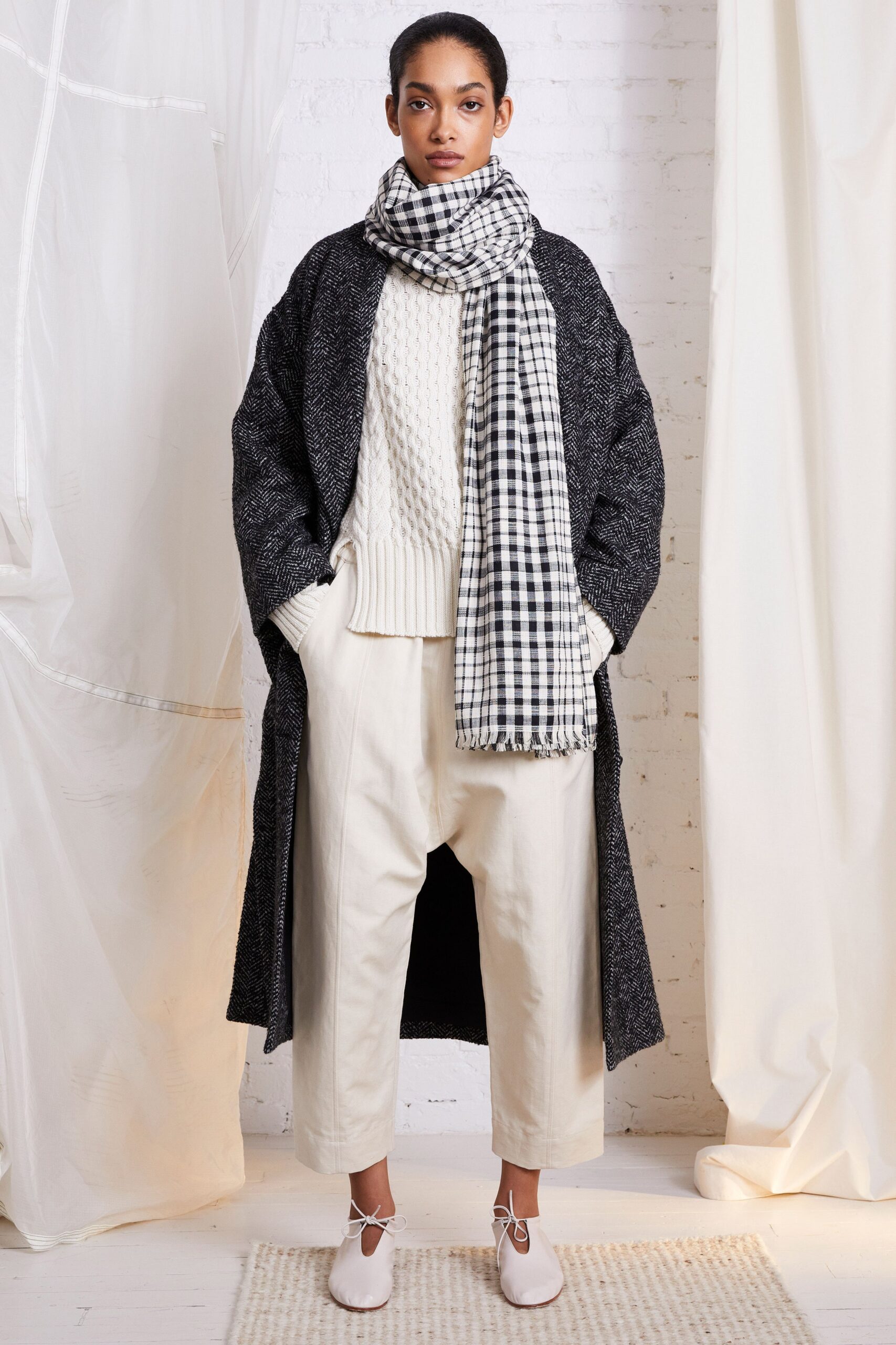 black wool coat with white sweater