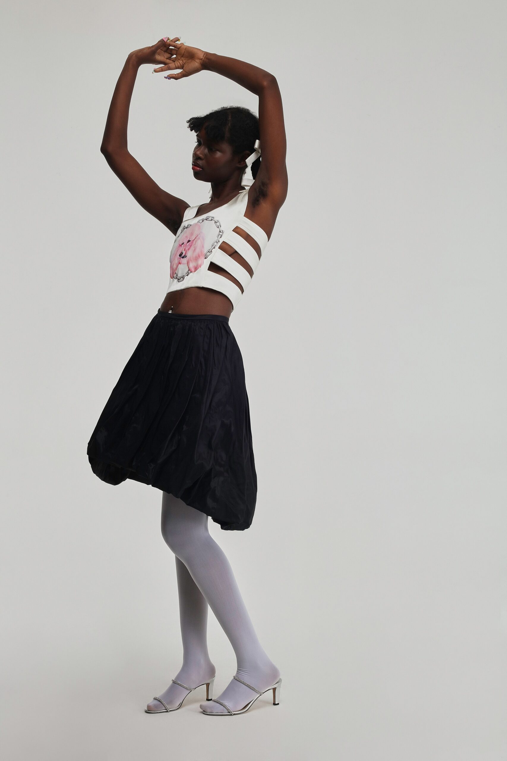 white crop-top black pleated skirt