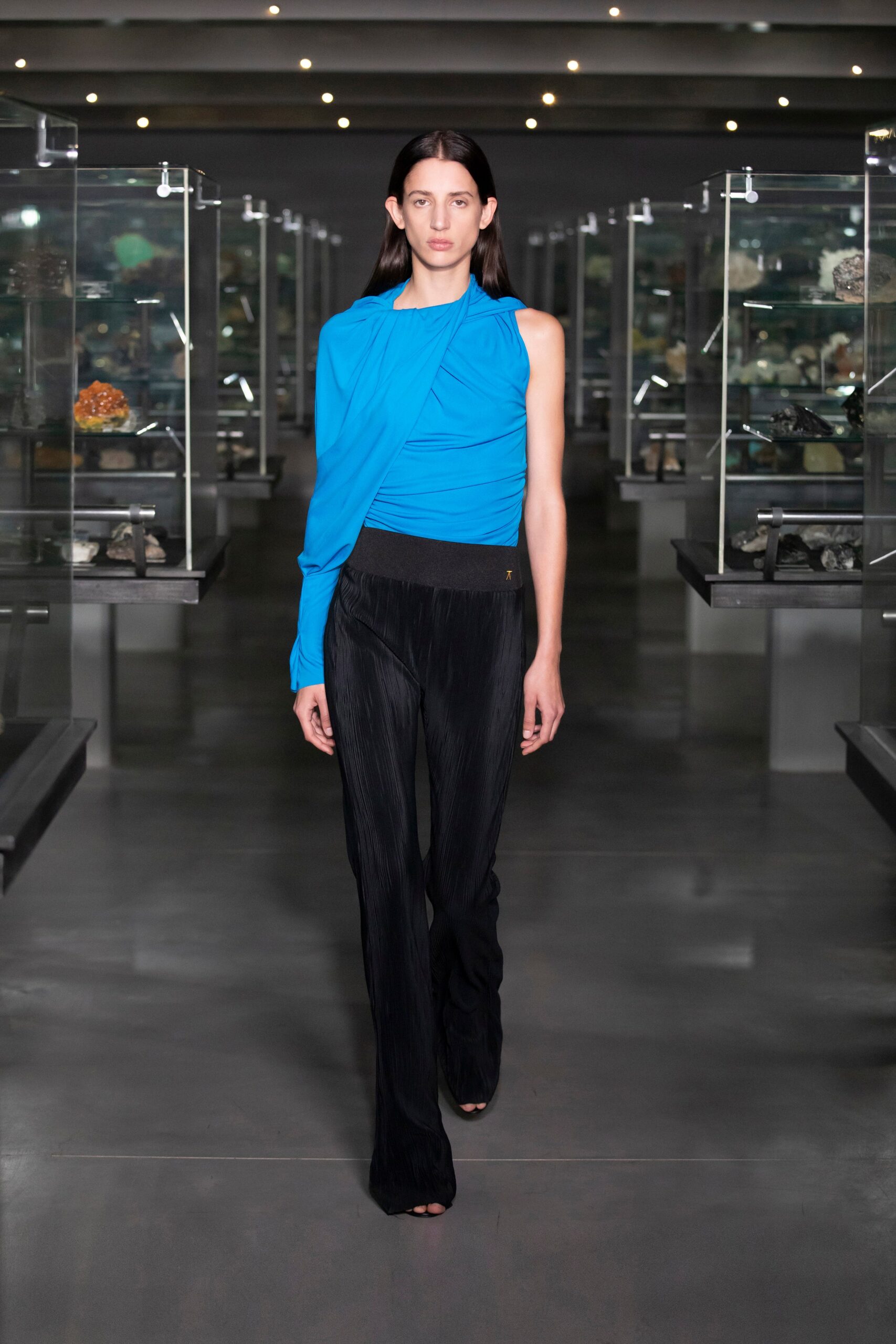 blue draped top with black pants