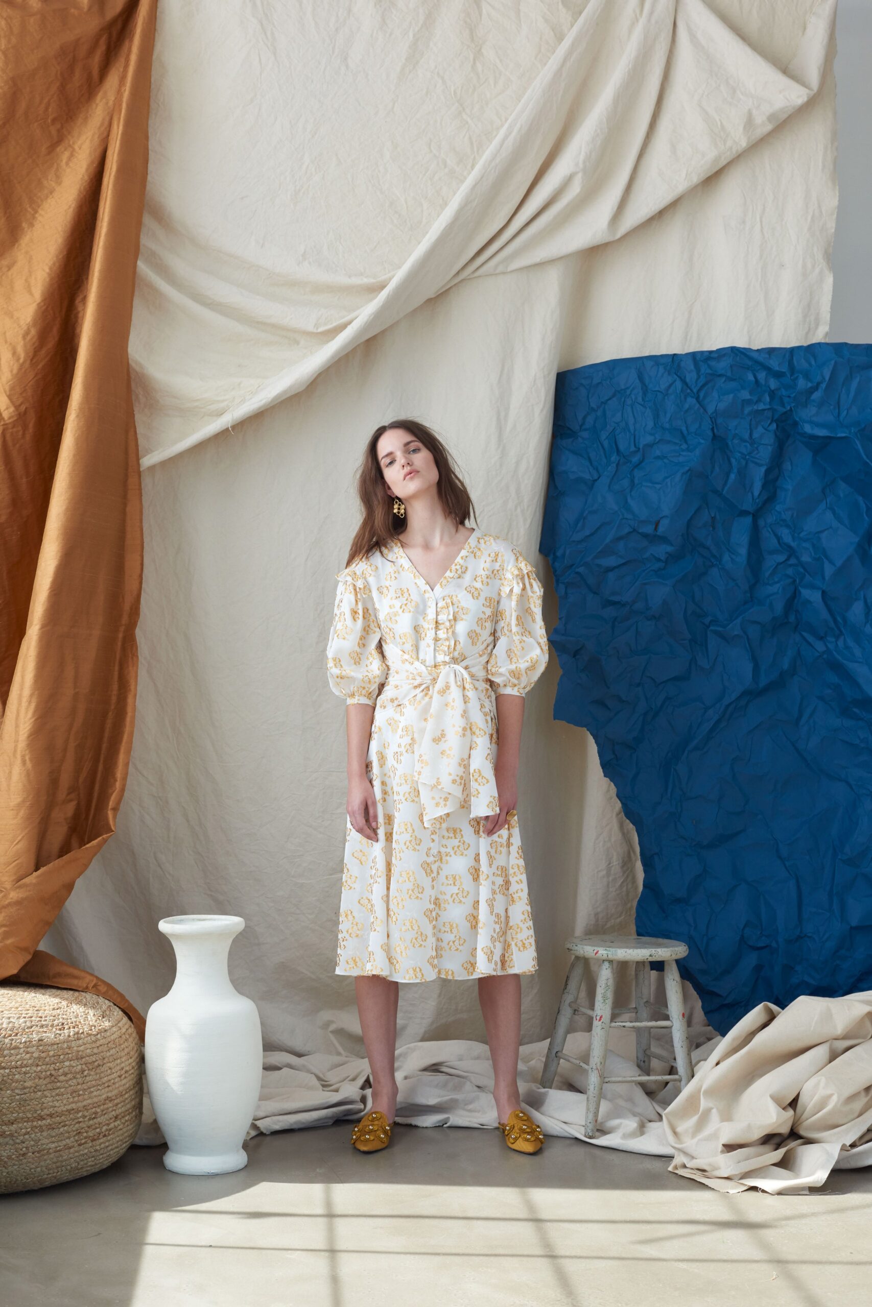 white printed midi dress with gold shoes