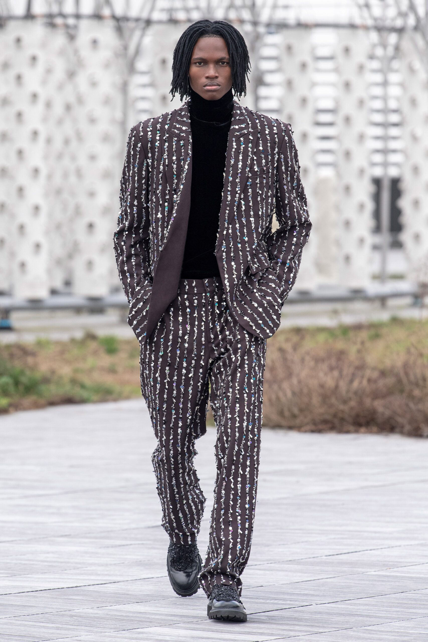brown and white striped suit with black turtleneck