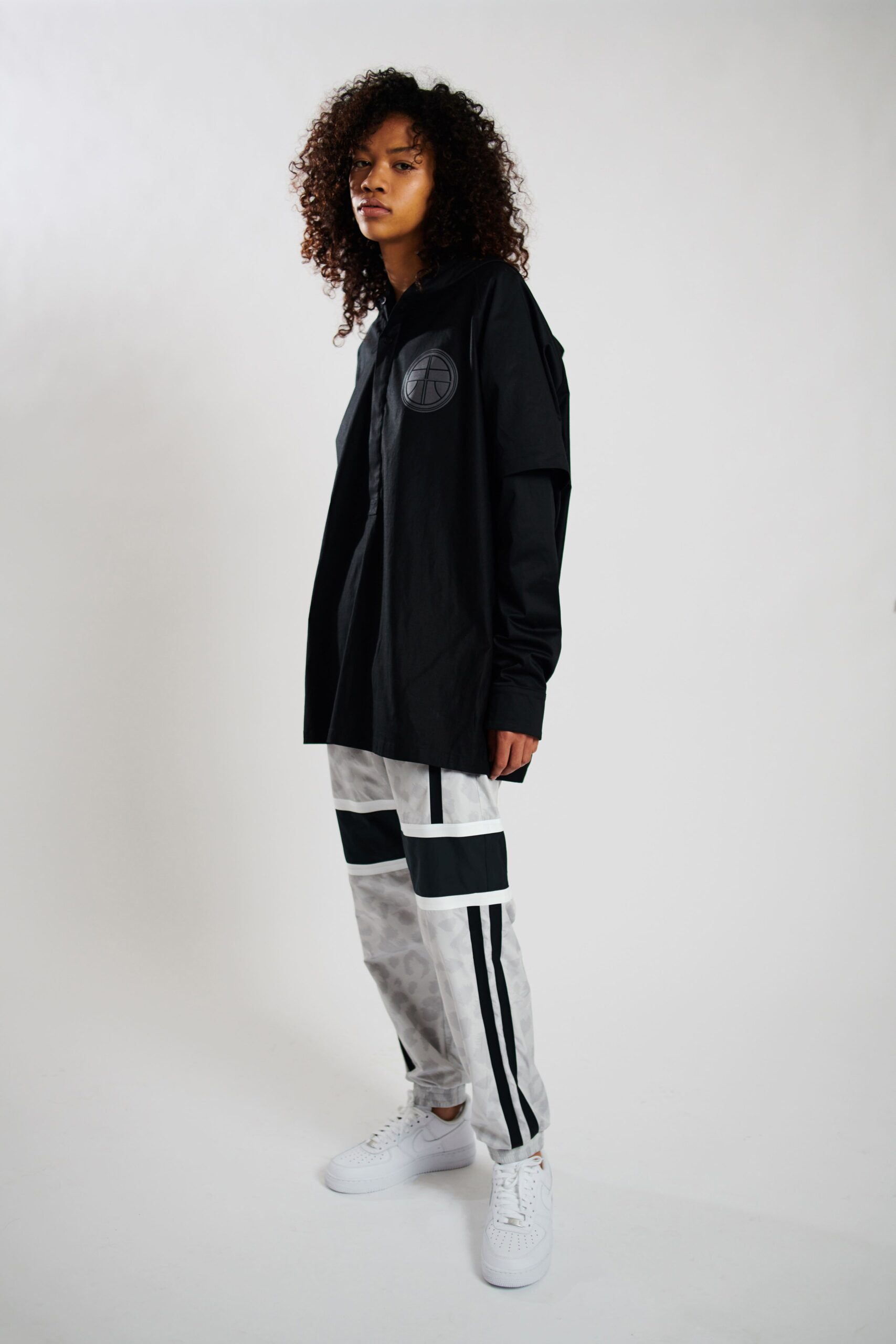 black relaxed shirt with white cargo pants