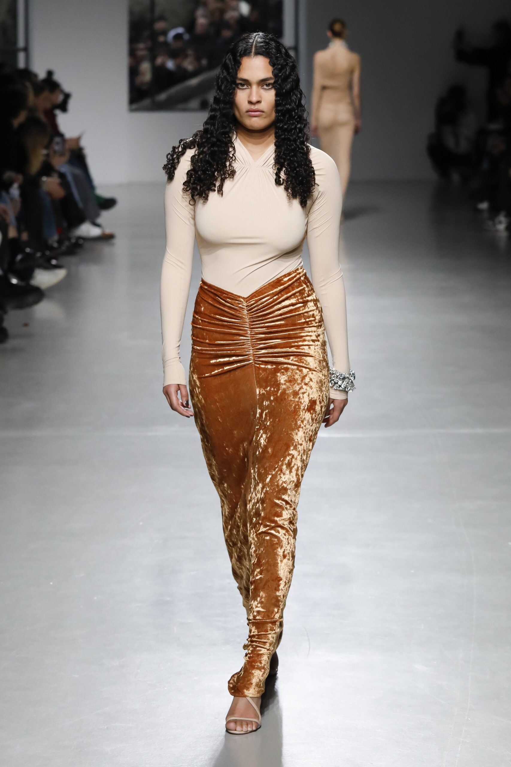 beige bodysuit and orange velvet skirt
