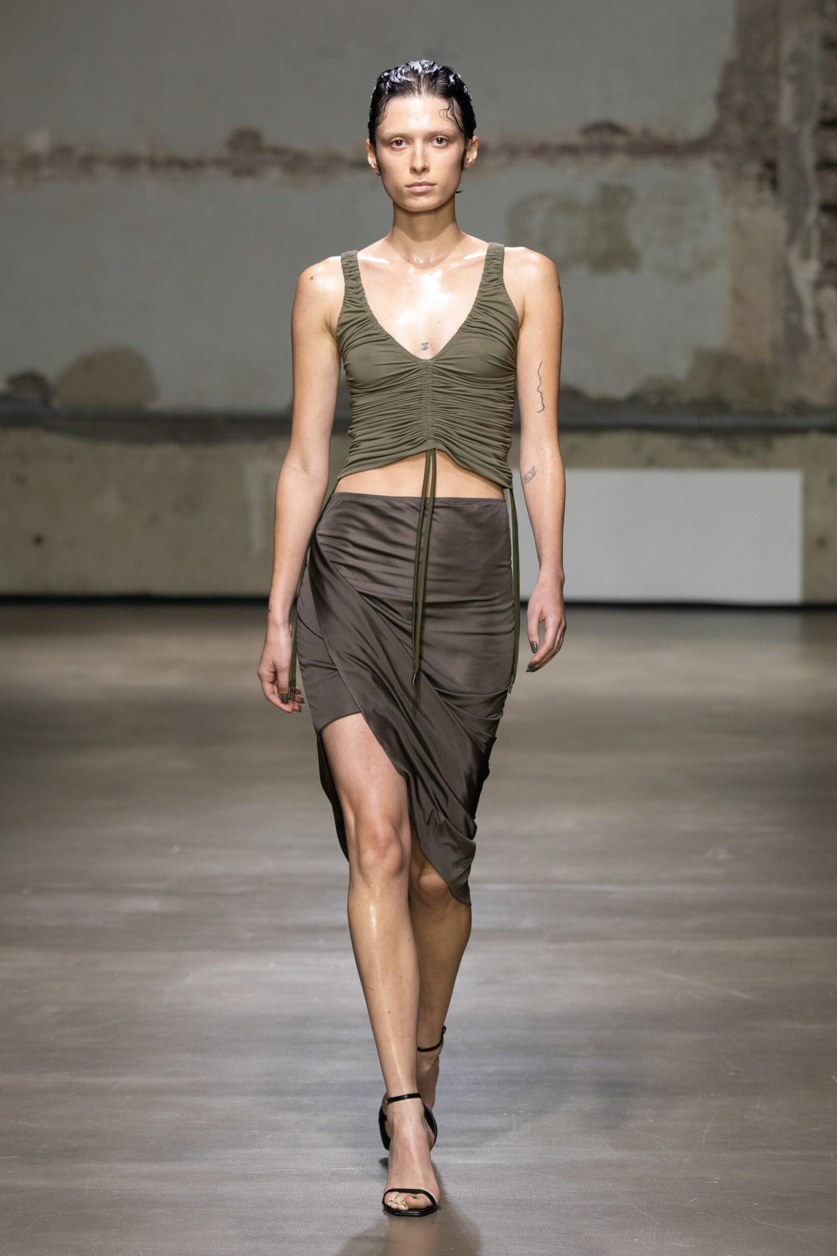green fitted top with brown skirt