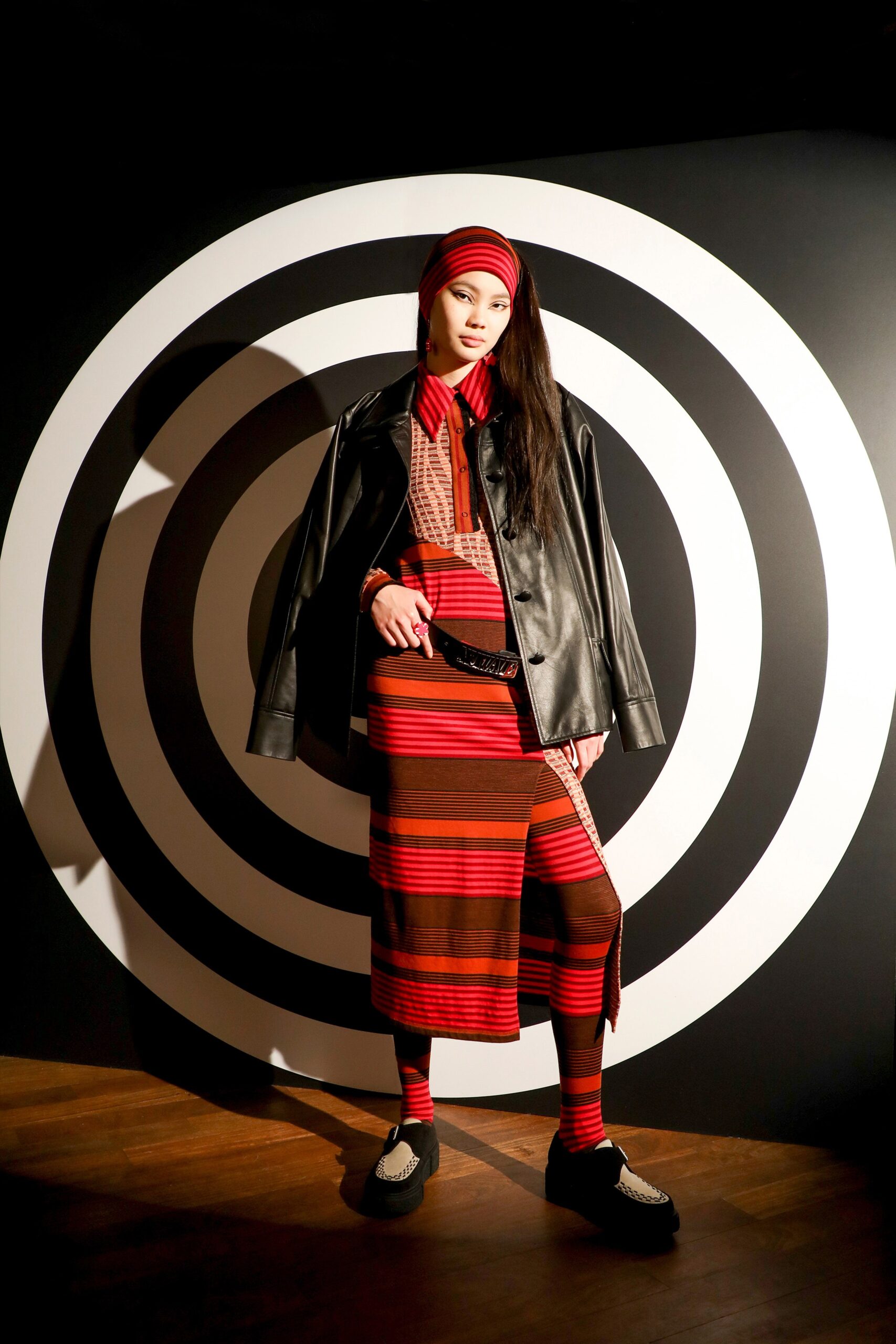 red and brown striped dress with leather jacket