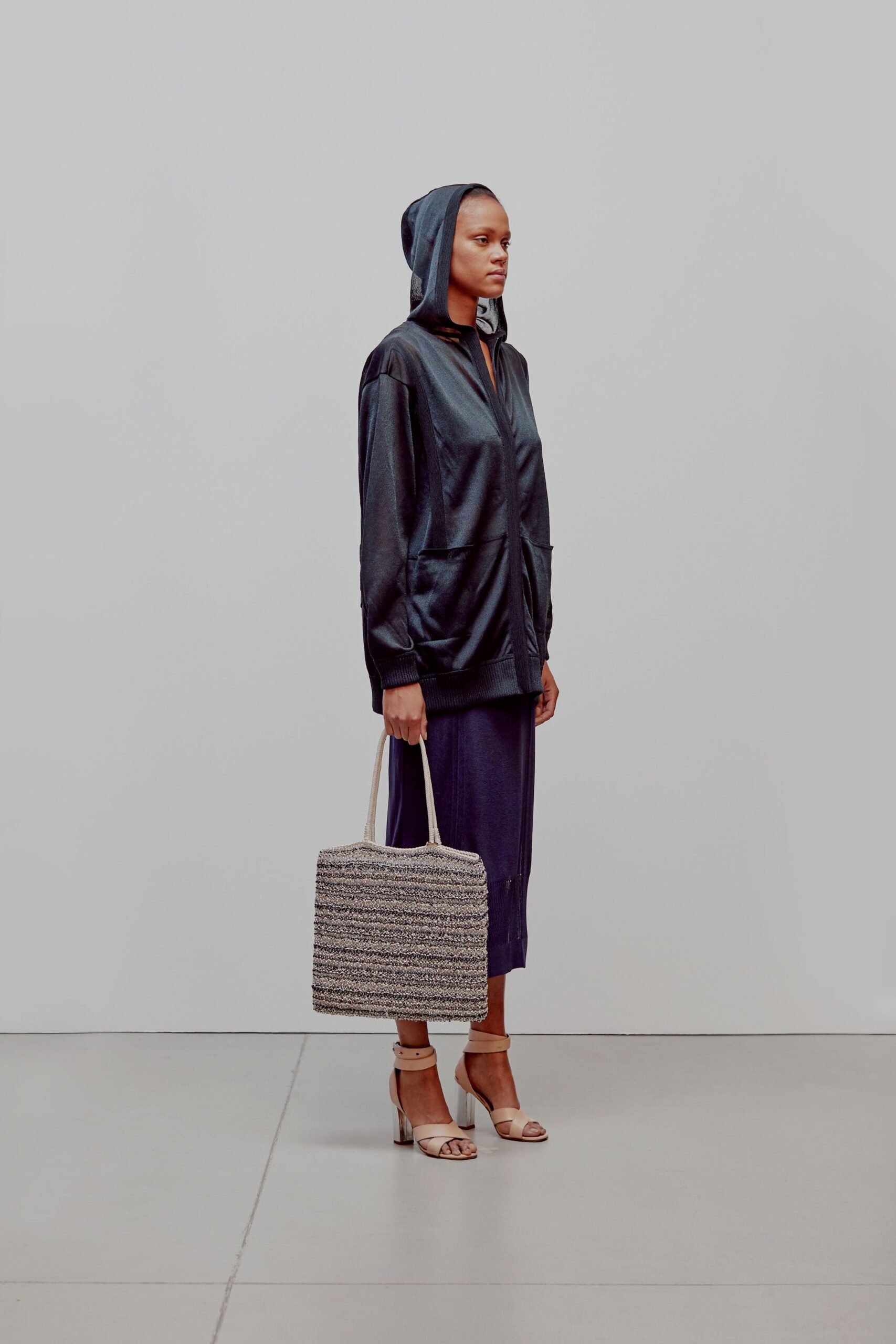 black leather hooded jacket with midi skirt