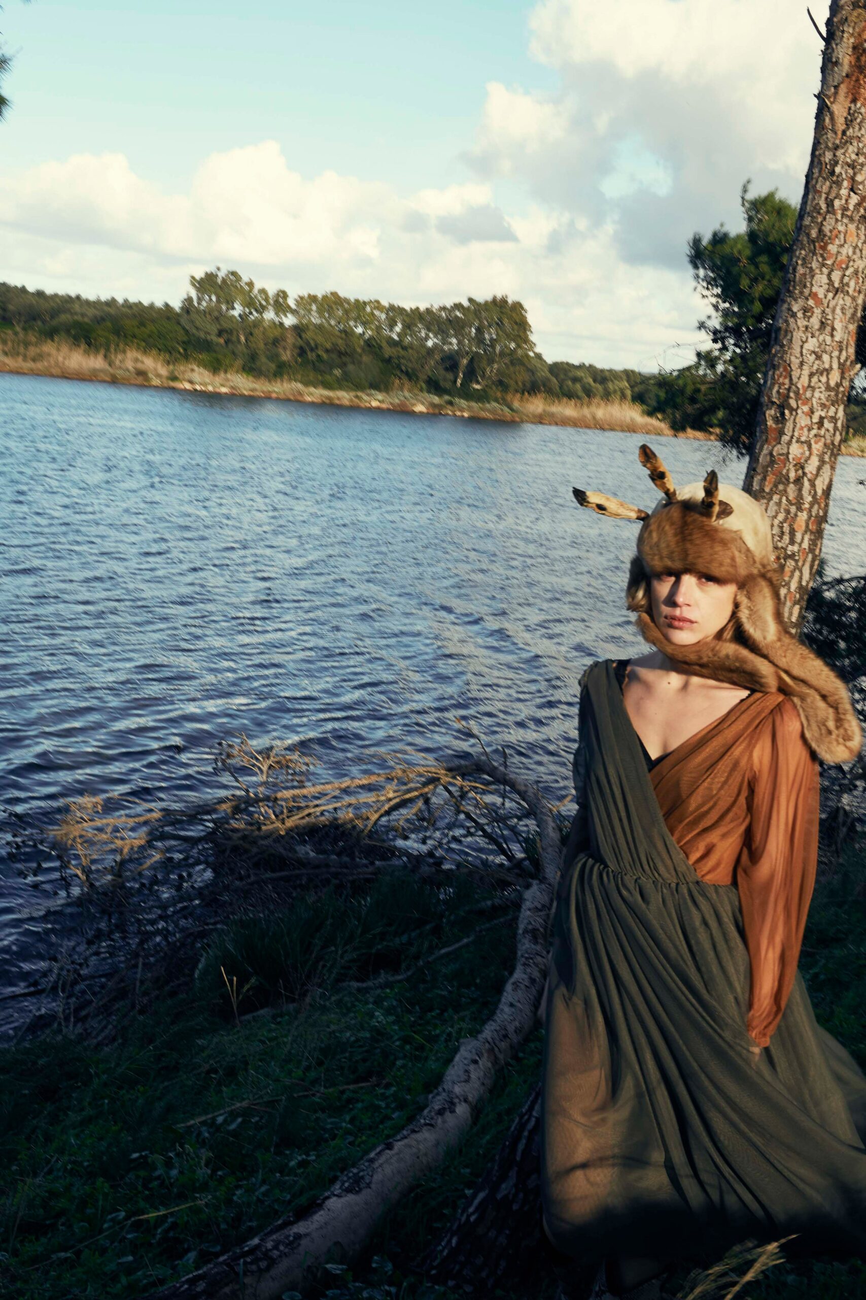 brown and green draped dress with fur hat
