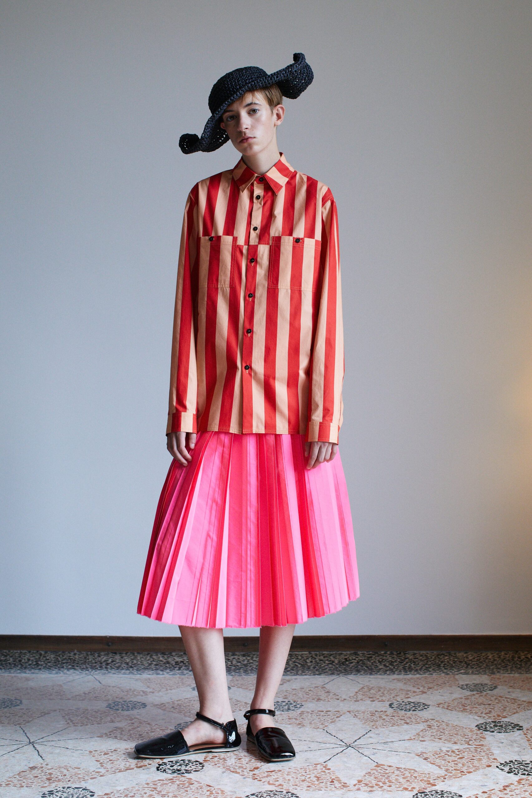 striped shirt and pleated pink skirt