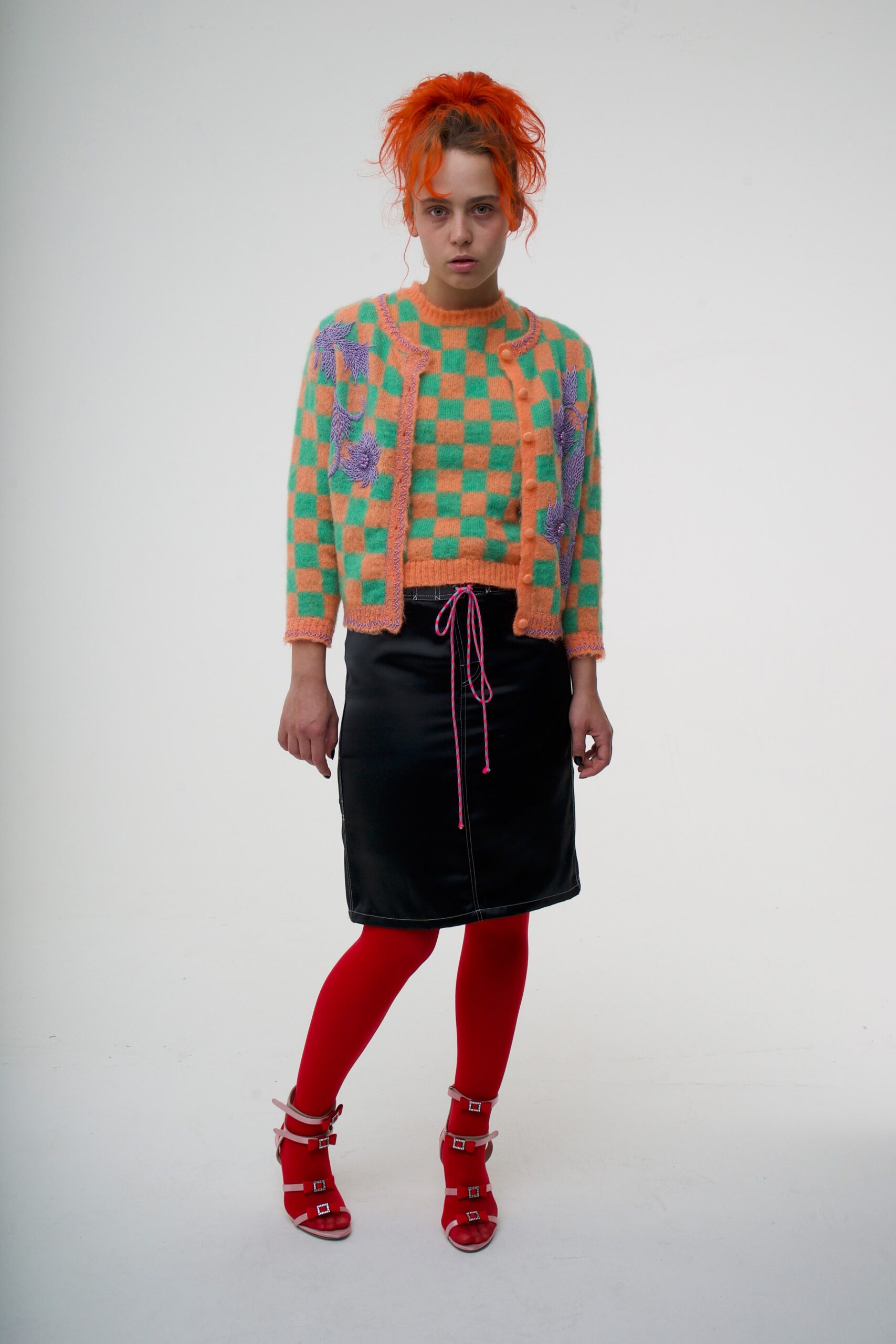 colorful cardigan and leather skirt