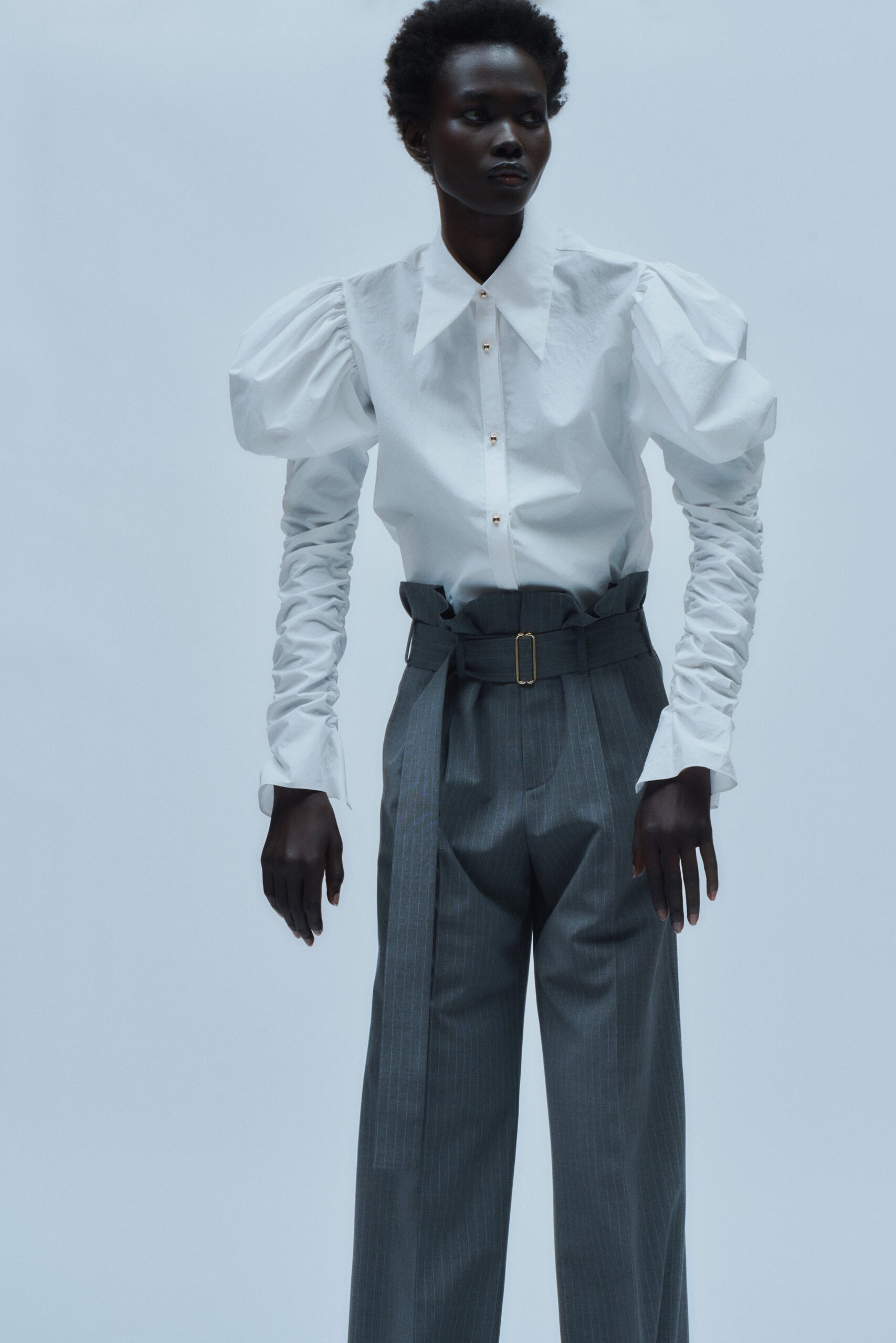 white fitted shirt and gray tailored pants