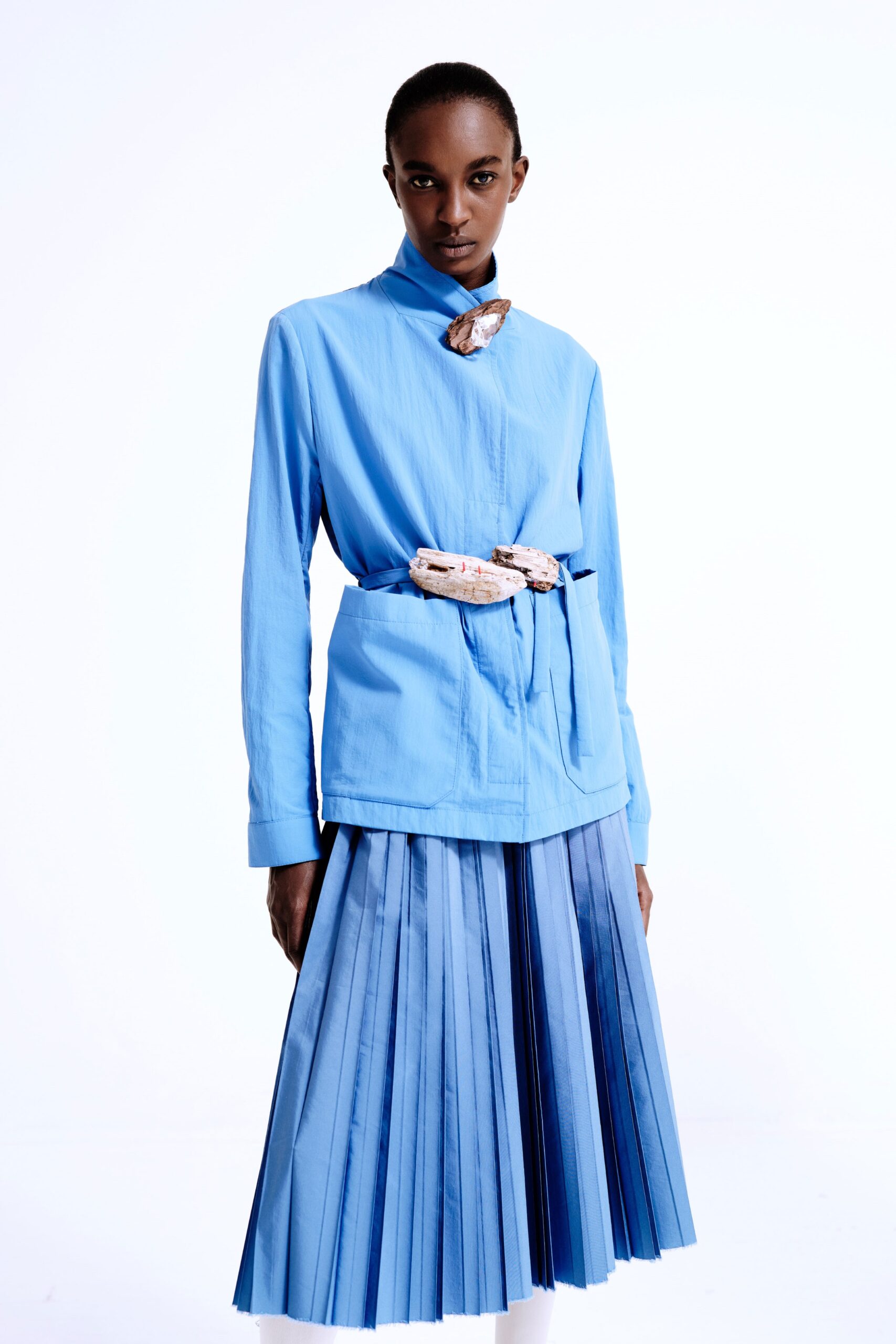 blue fitted jacket and pleated skirt
