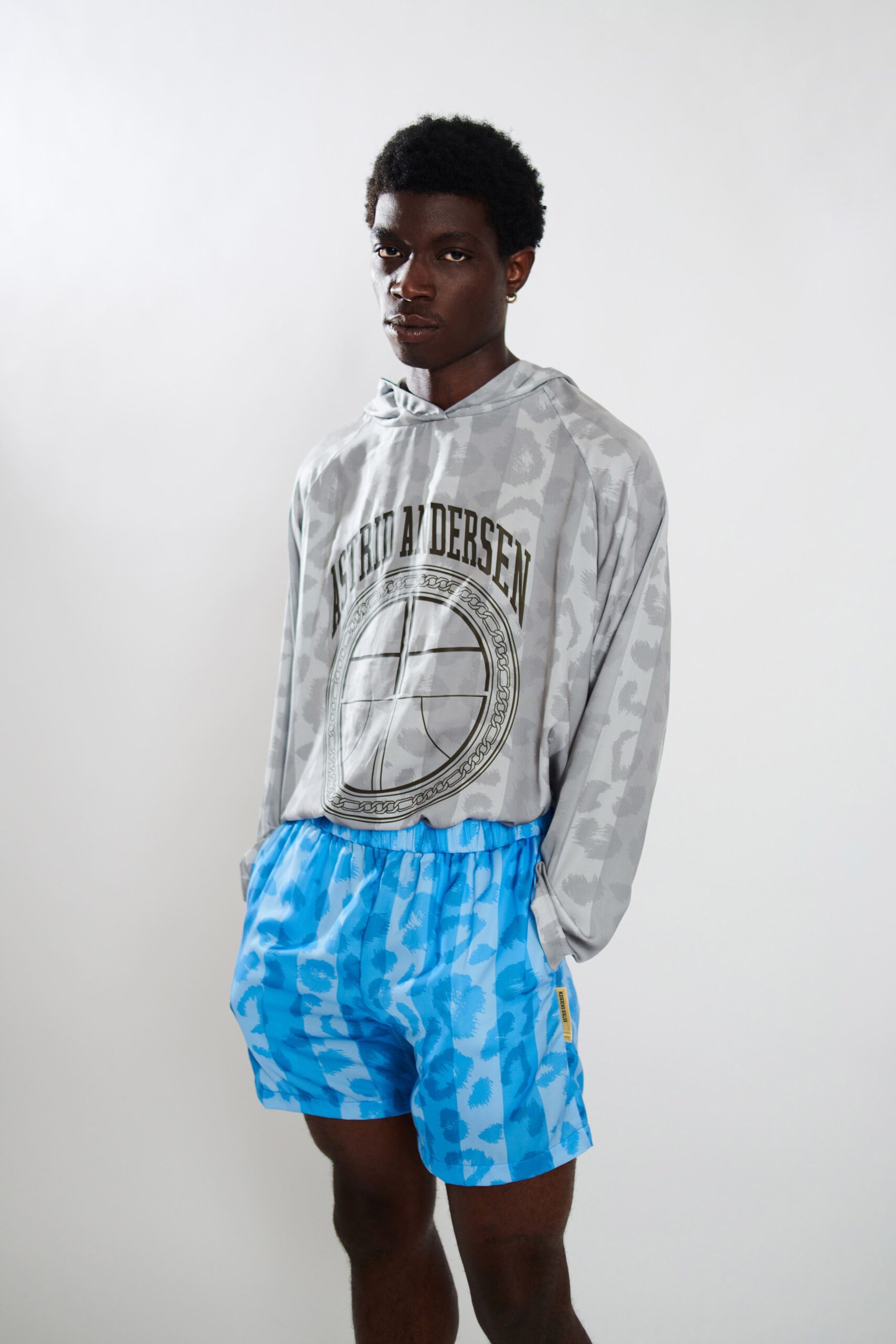gray printed hoodie and blue shorts