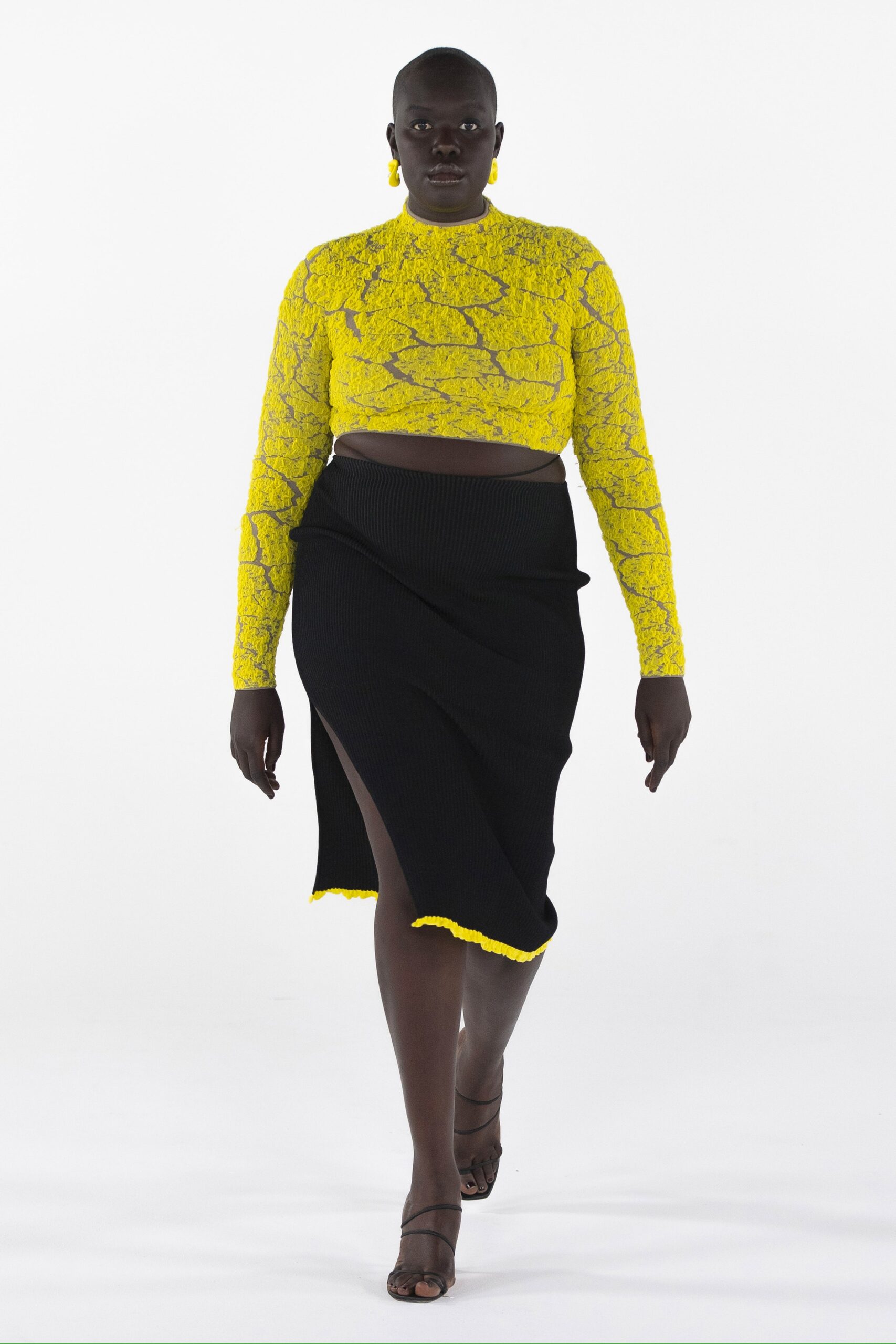 fitted yellow top and black skirt