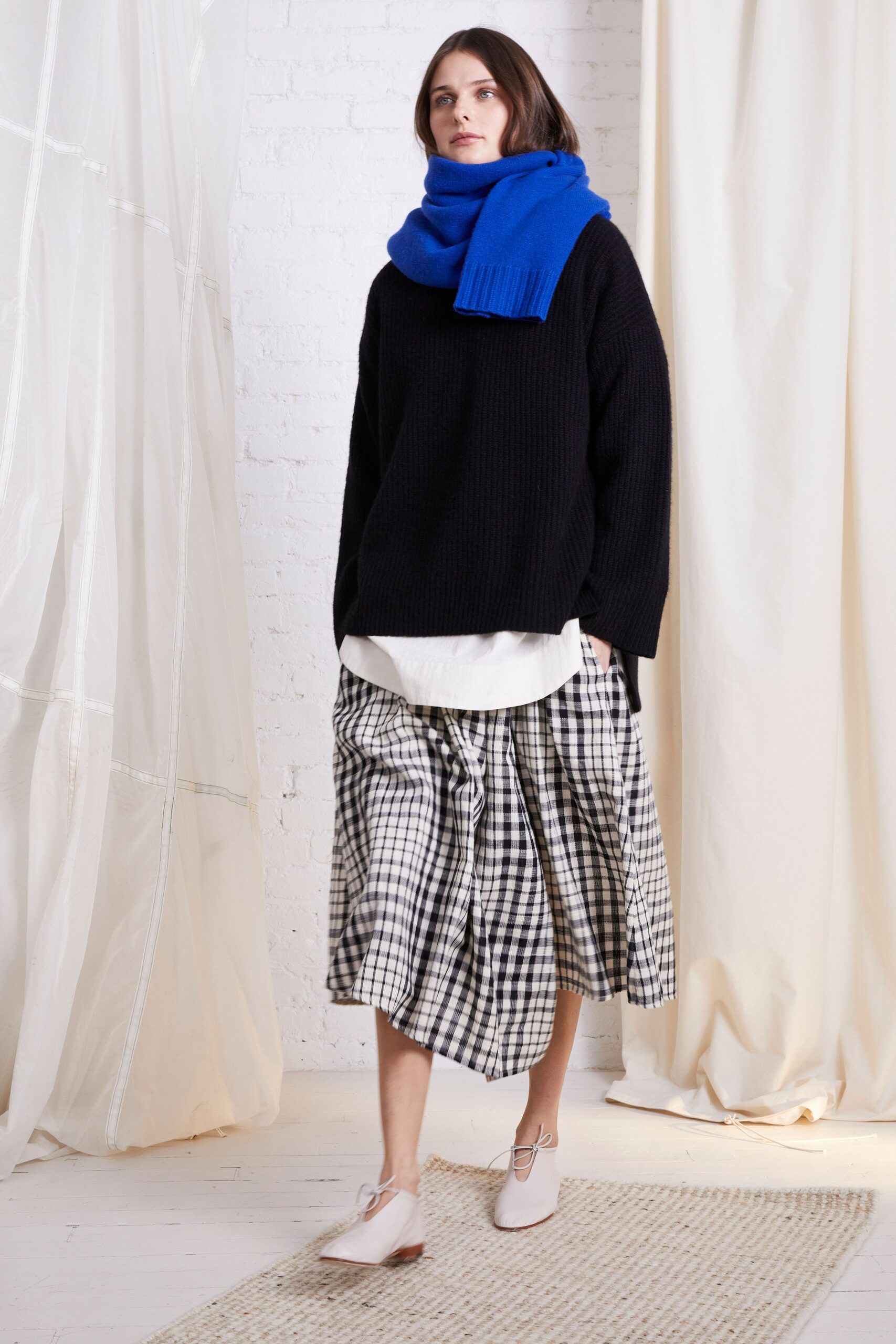 black oversized sweater with checked skirt
