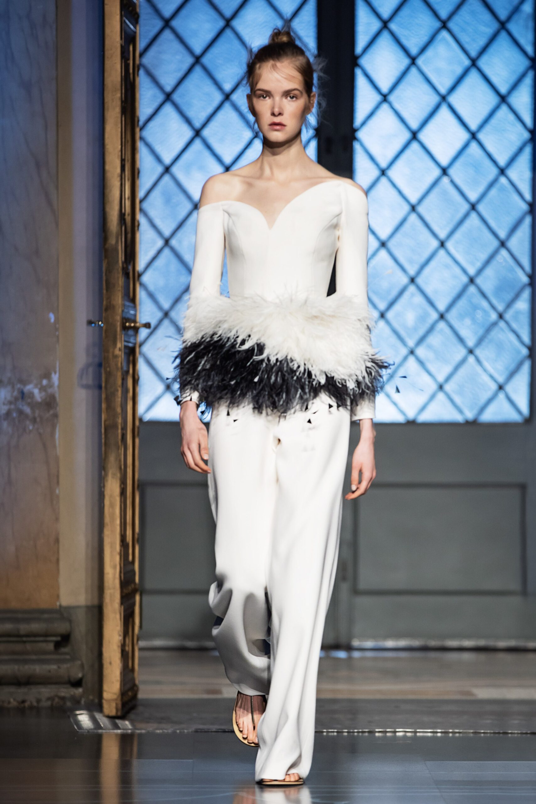 white fitted jumpsuit with feather detail