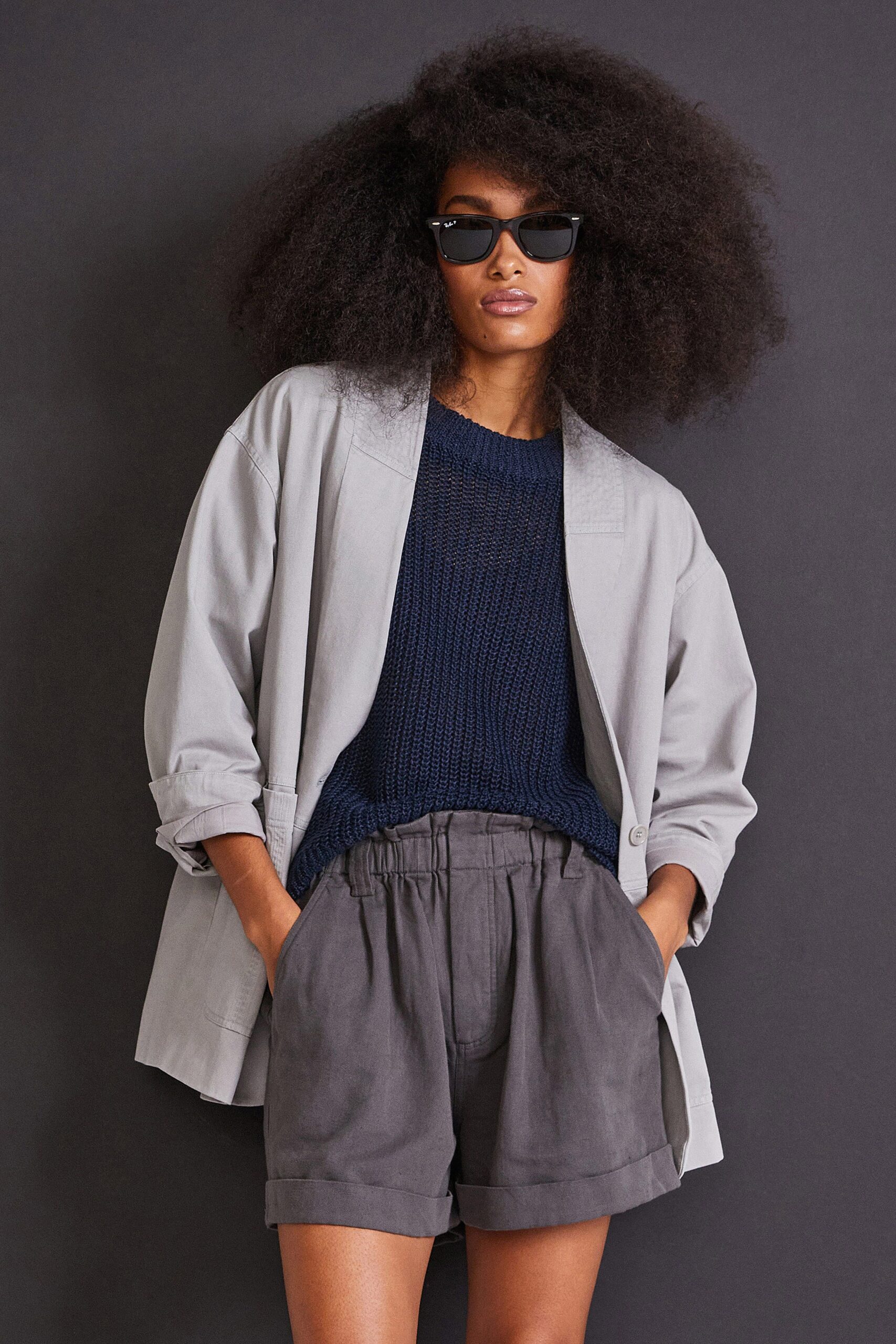 gray jacket blue top gray shorts