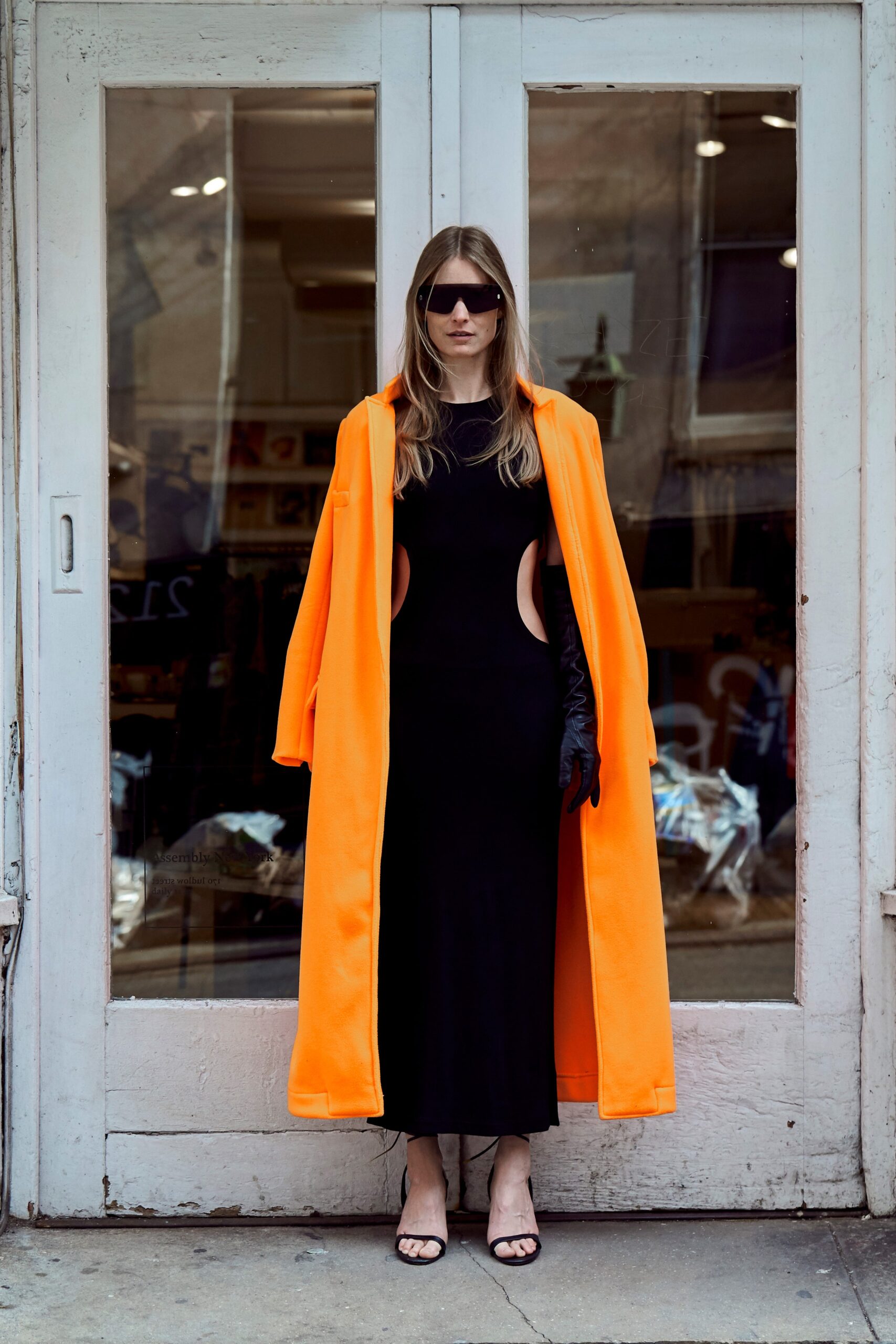 black fitted dress with orange coat