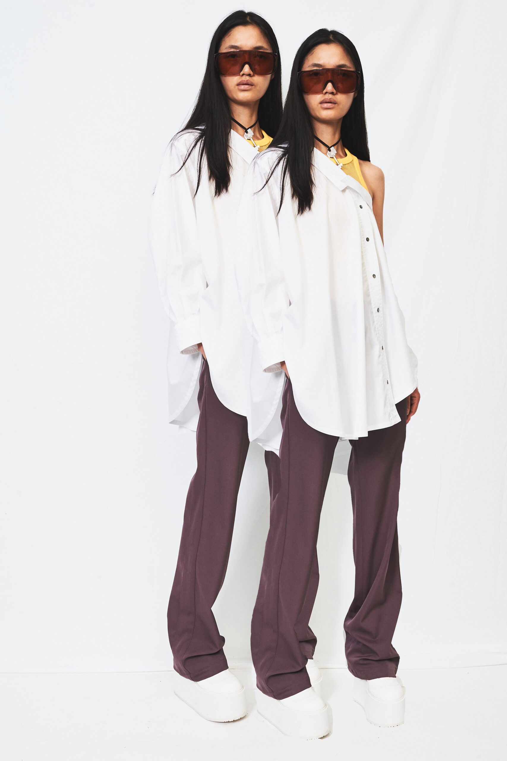 white relaxed shirt with purple pants