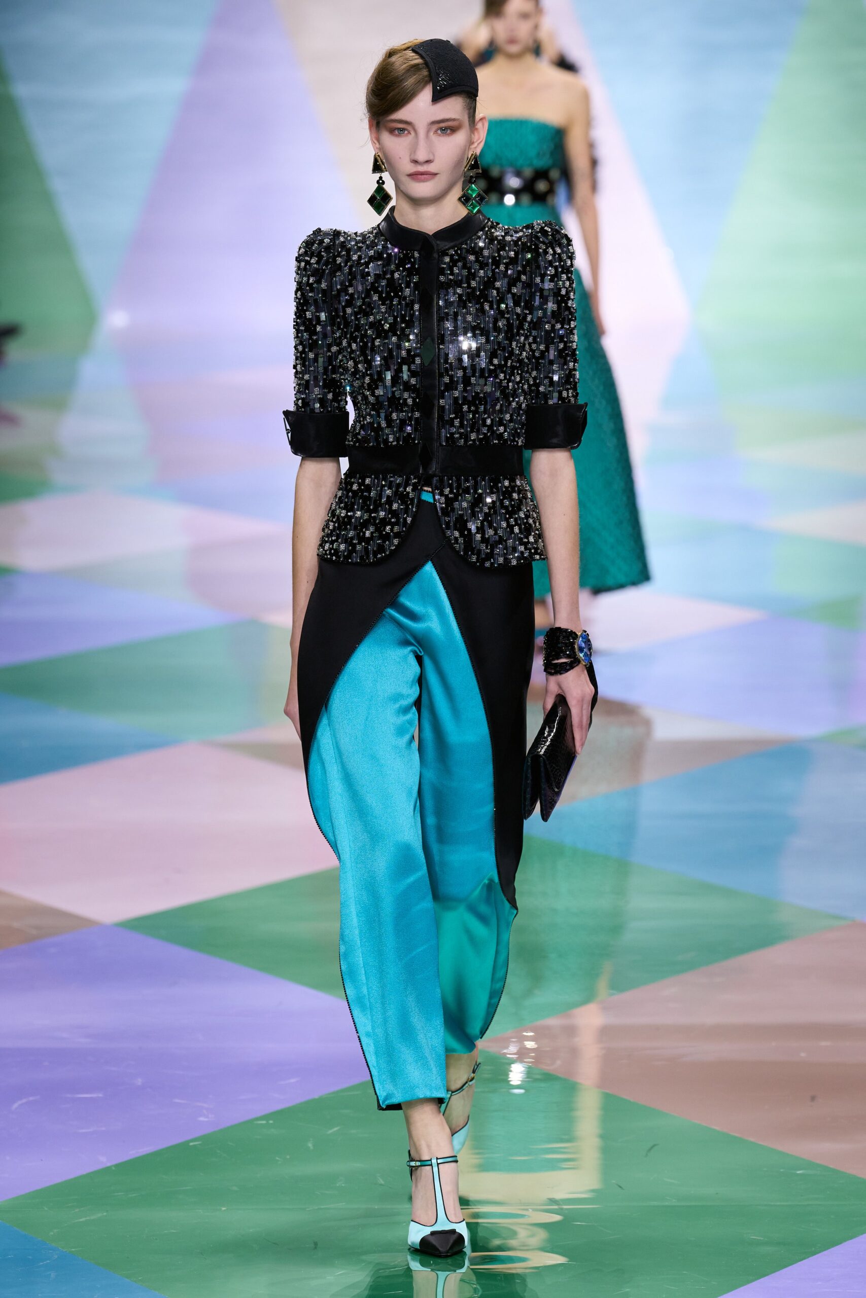 black beaded blazer with blue pants