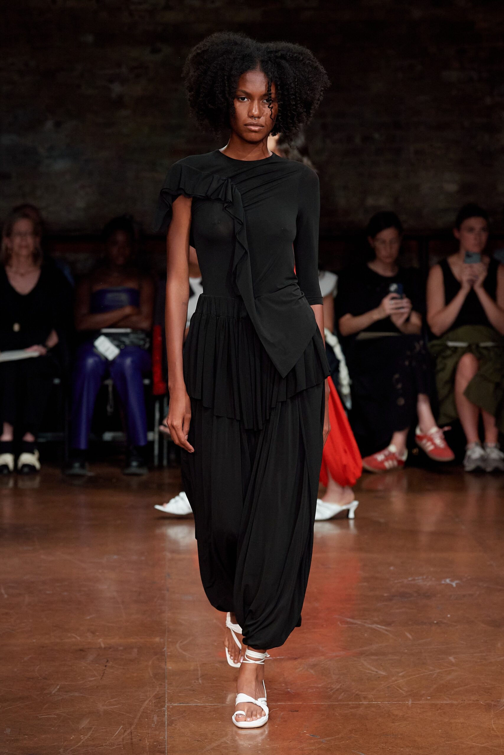 black fitted asymmetric dress with white shoes