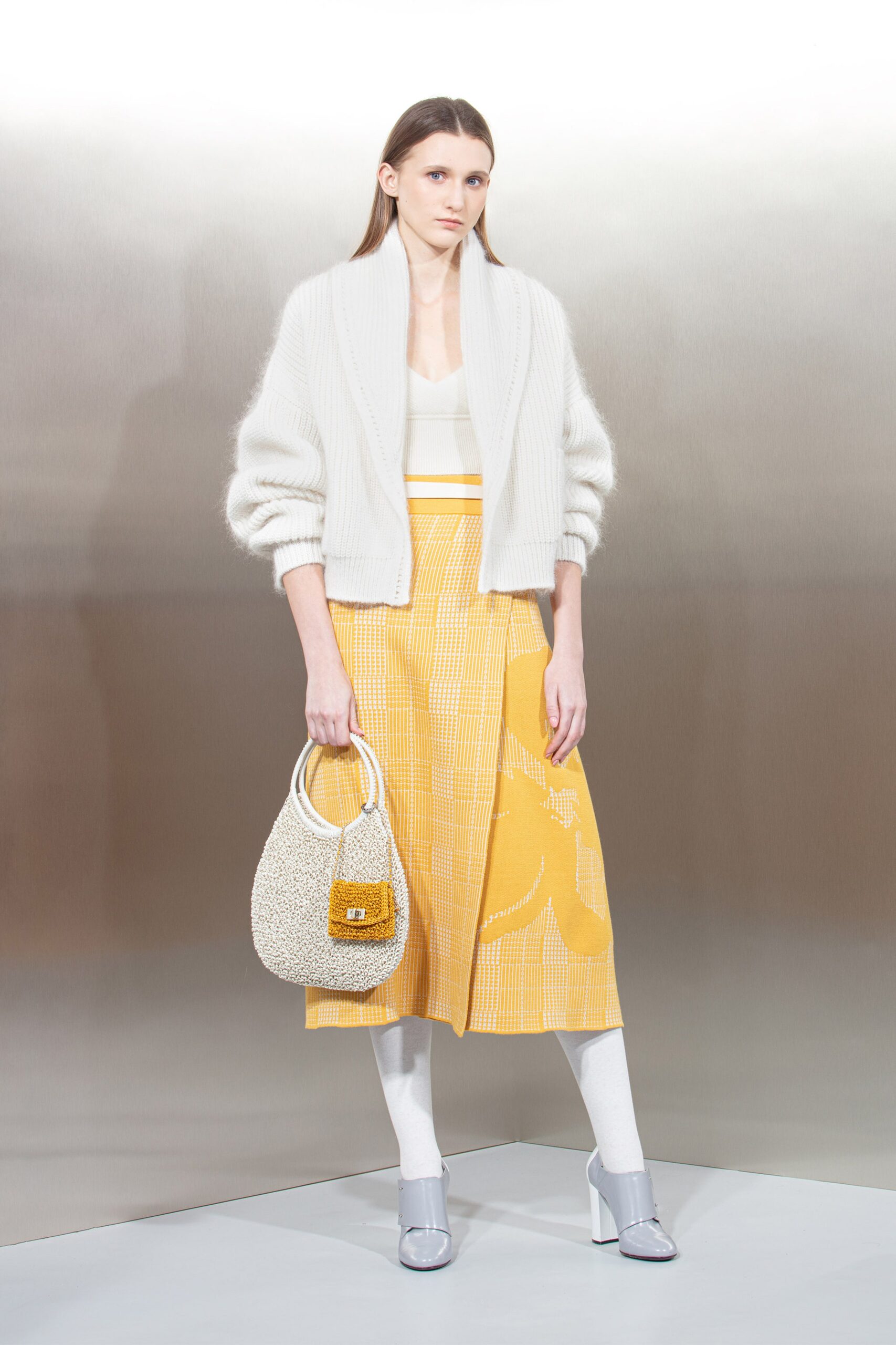 white cardigan yellow pleated skirt