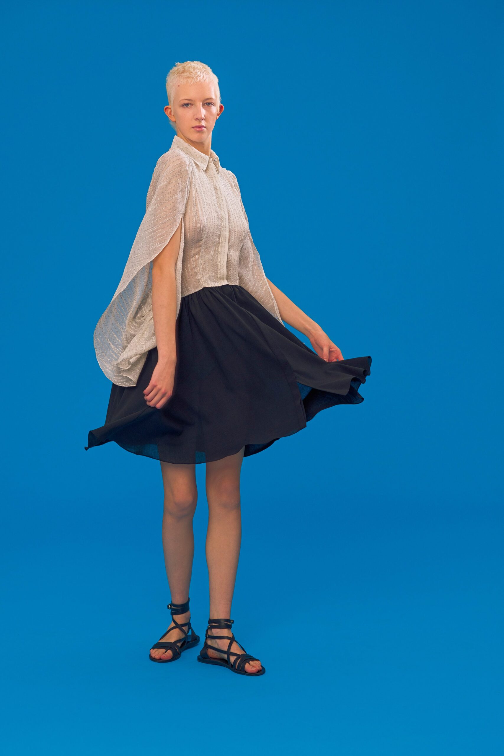 black mini dress with white cape
