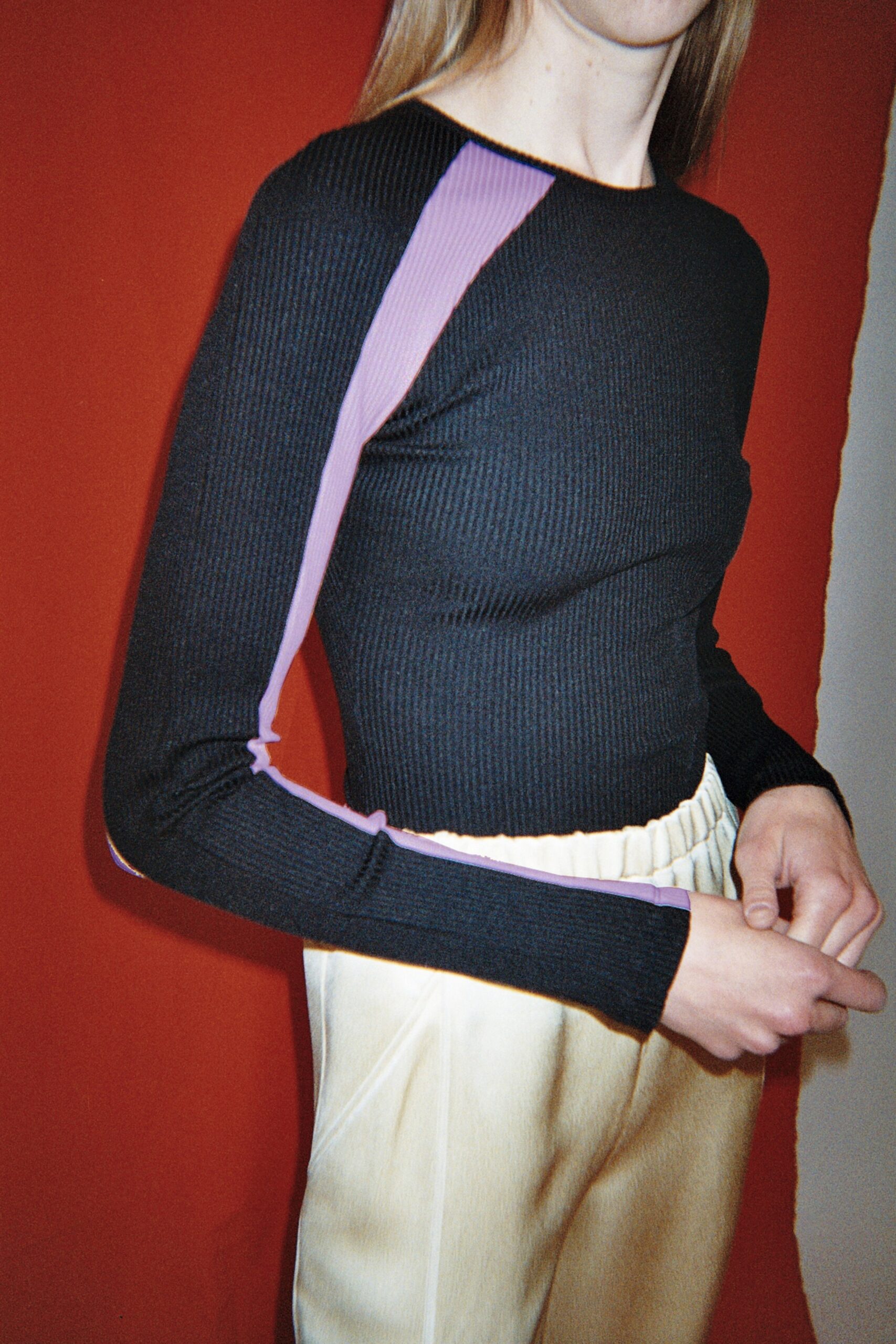 black fitted top and beige pants